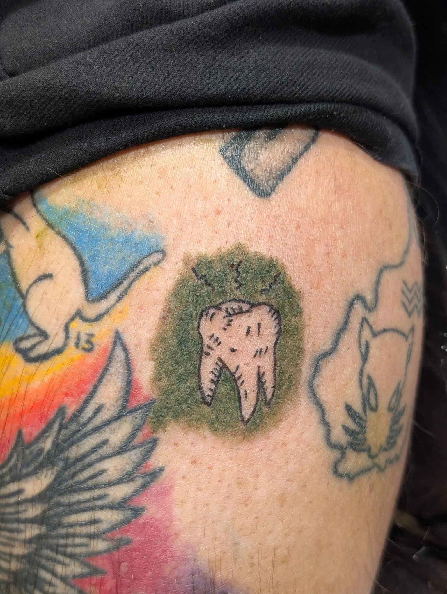 A tattoo of a tooth.