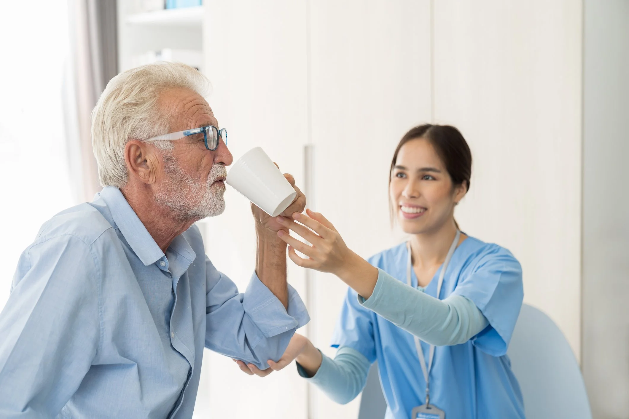 Speech-language pathologist providing in-home adult therapy session with client 