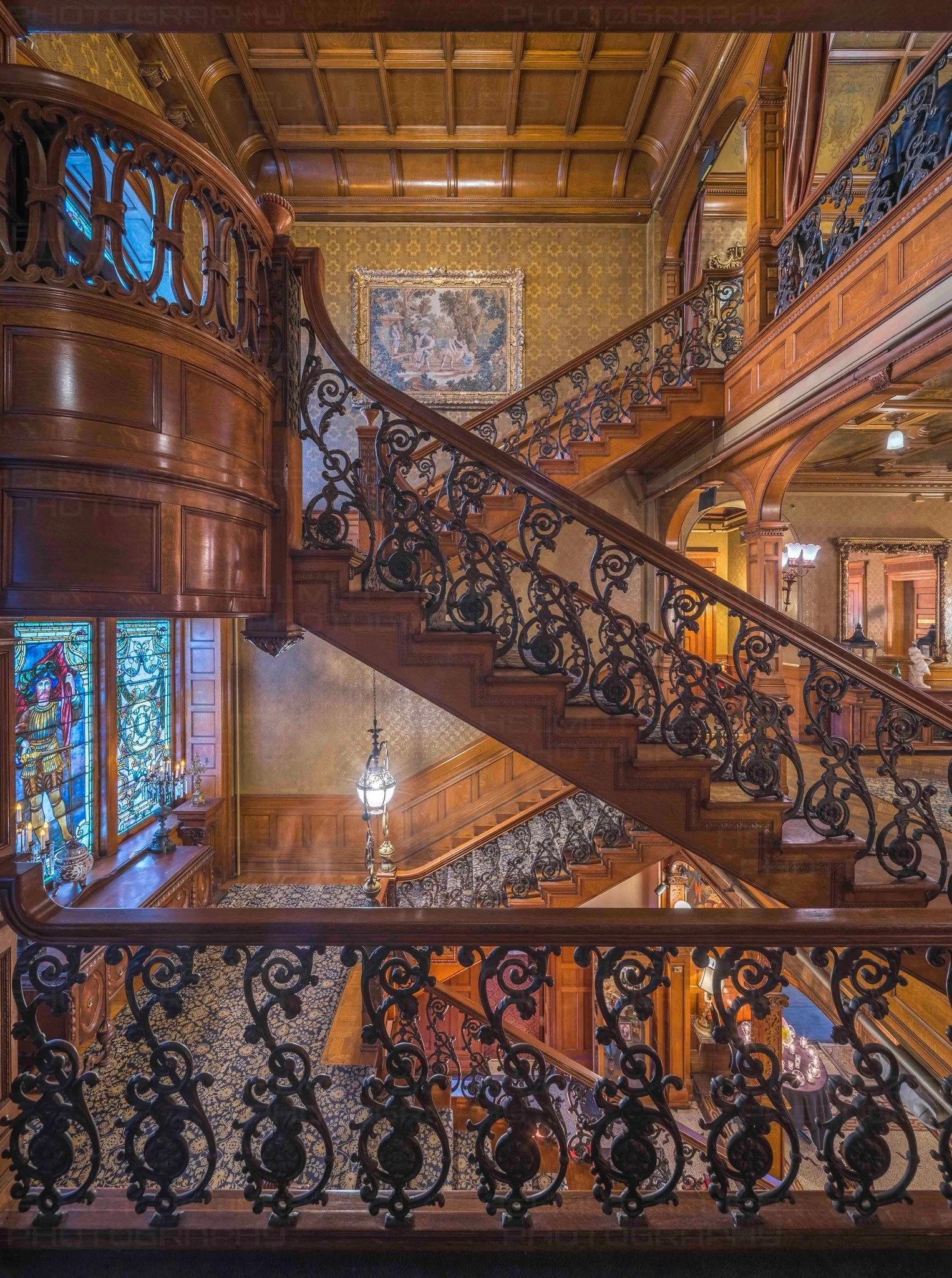 Photo of interior of building with ornate railings and wood