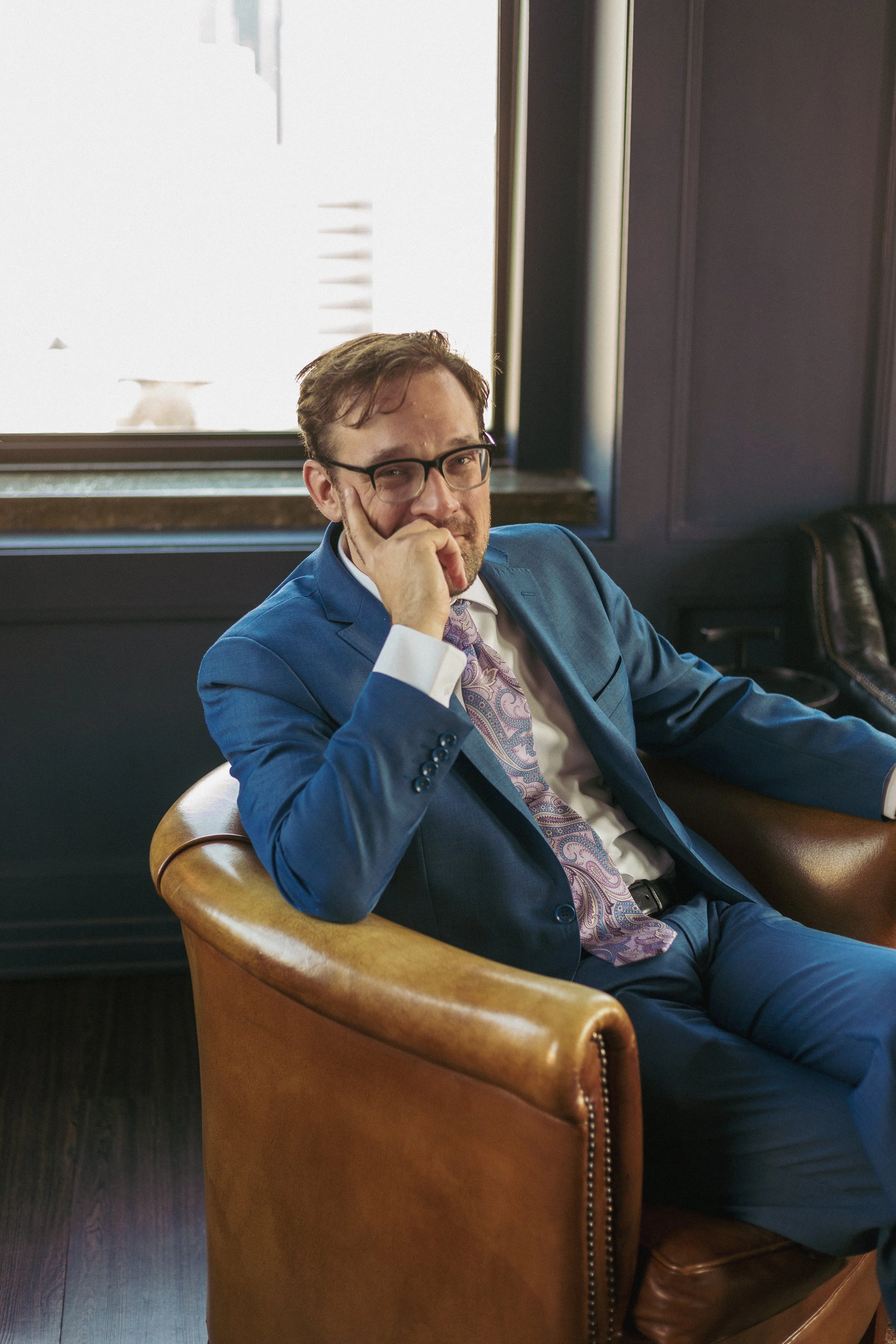 Picture of Dan Austin in blue suit, looking at camera