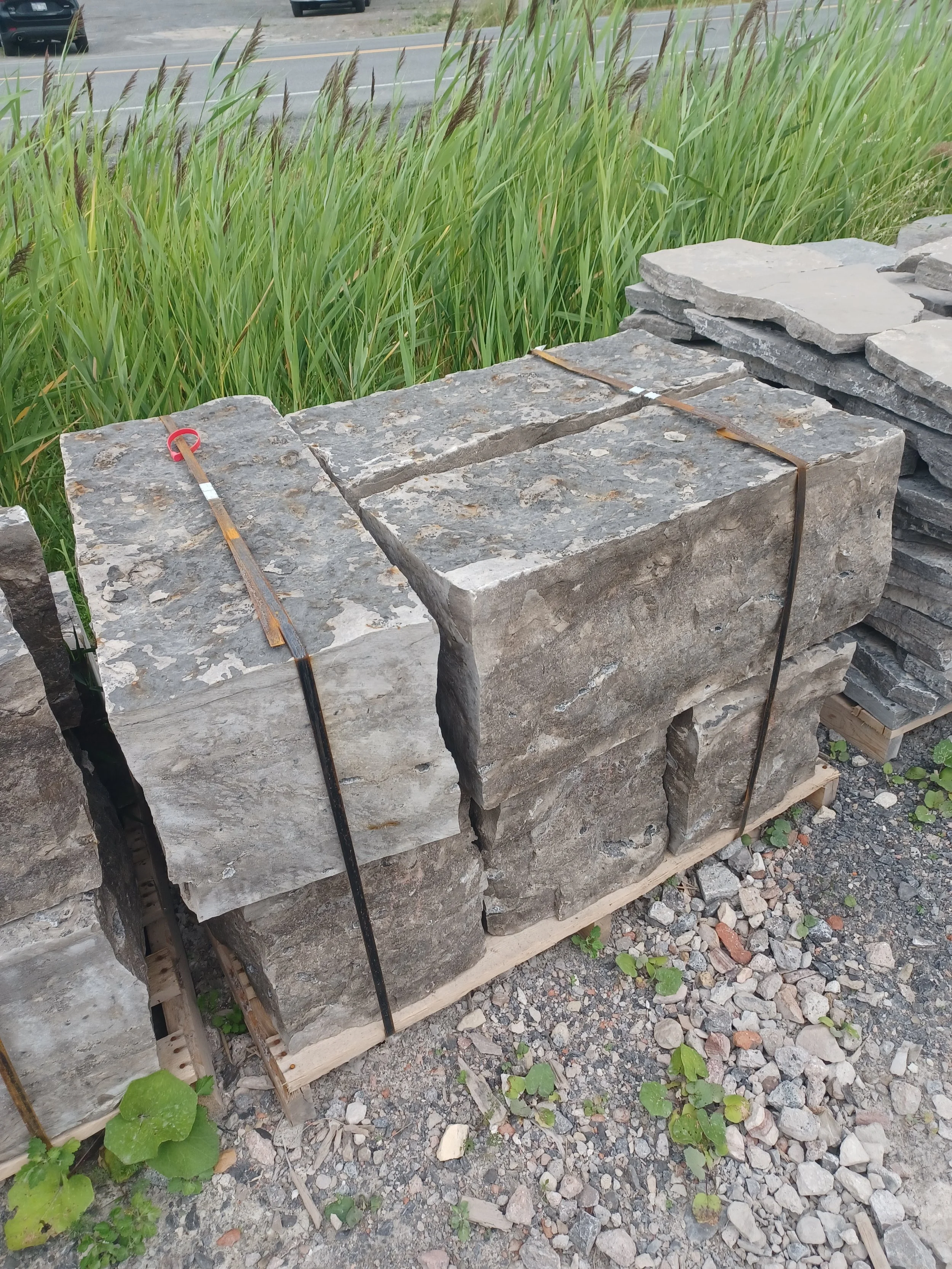 Stacked rough cut stone bricks on a wooden pallet.
