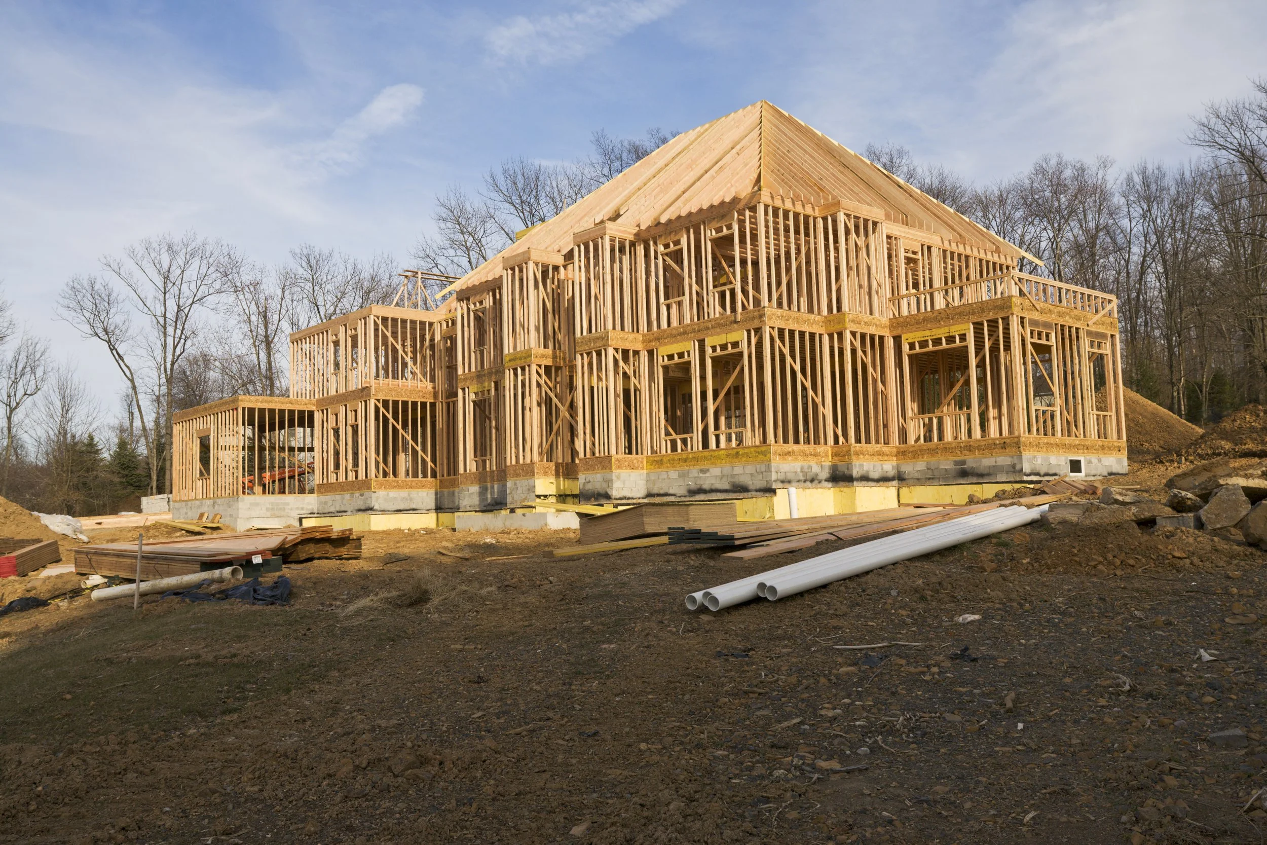 Wood-framed custom home under construction showcasing residential structural engineering and structural framing.