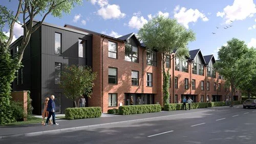 A modern residential apartment building with brick and black exterior, surrounded by trees and greenery, with people walking on the sidewalk.