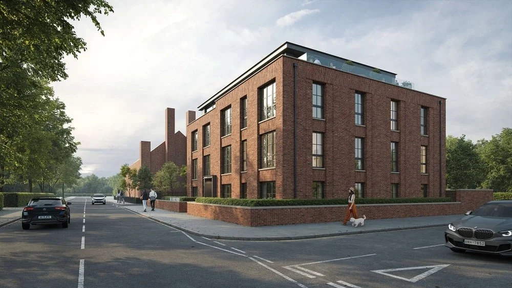 Modern brick building on a city street with parked cars and pedestrians, surrounded by trees.