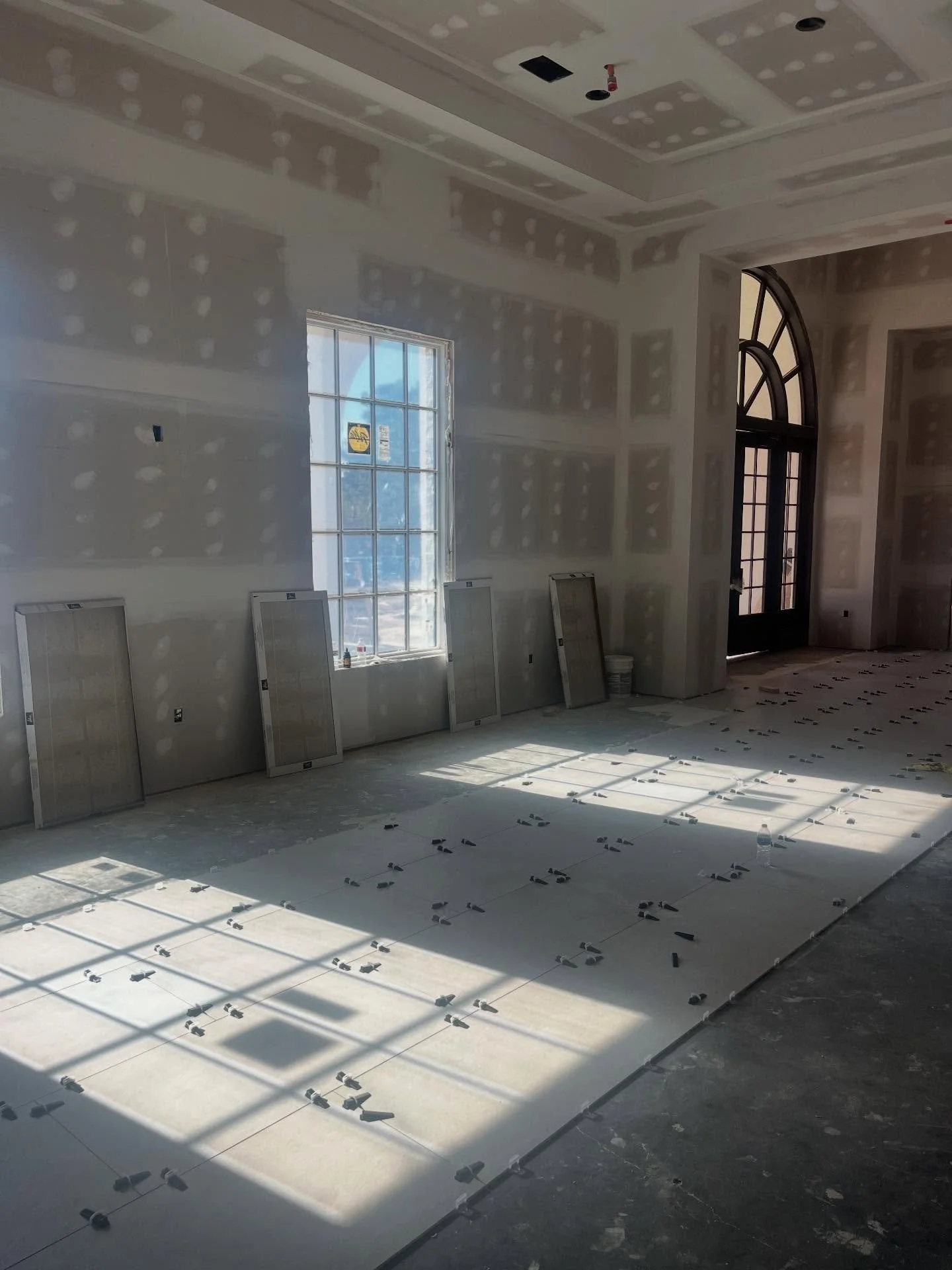 Ballroom tile going in, in the afternoon sun.