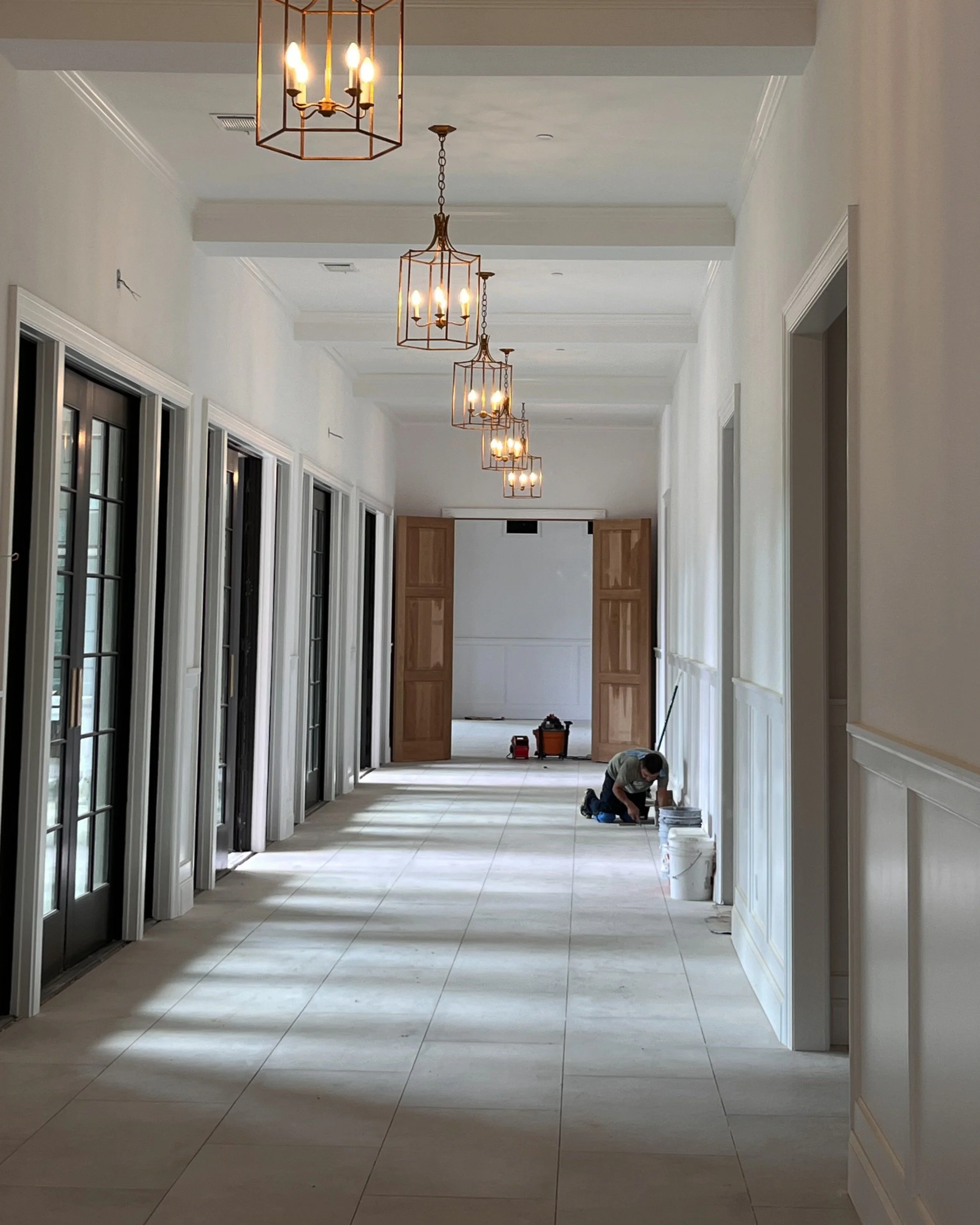 Just beyond the chapel, a wall of glass doors swings open to reveal cocktail hour waiting on the other side.