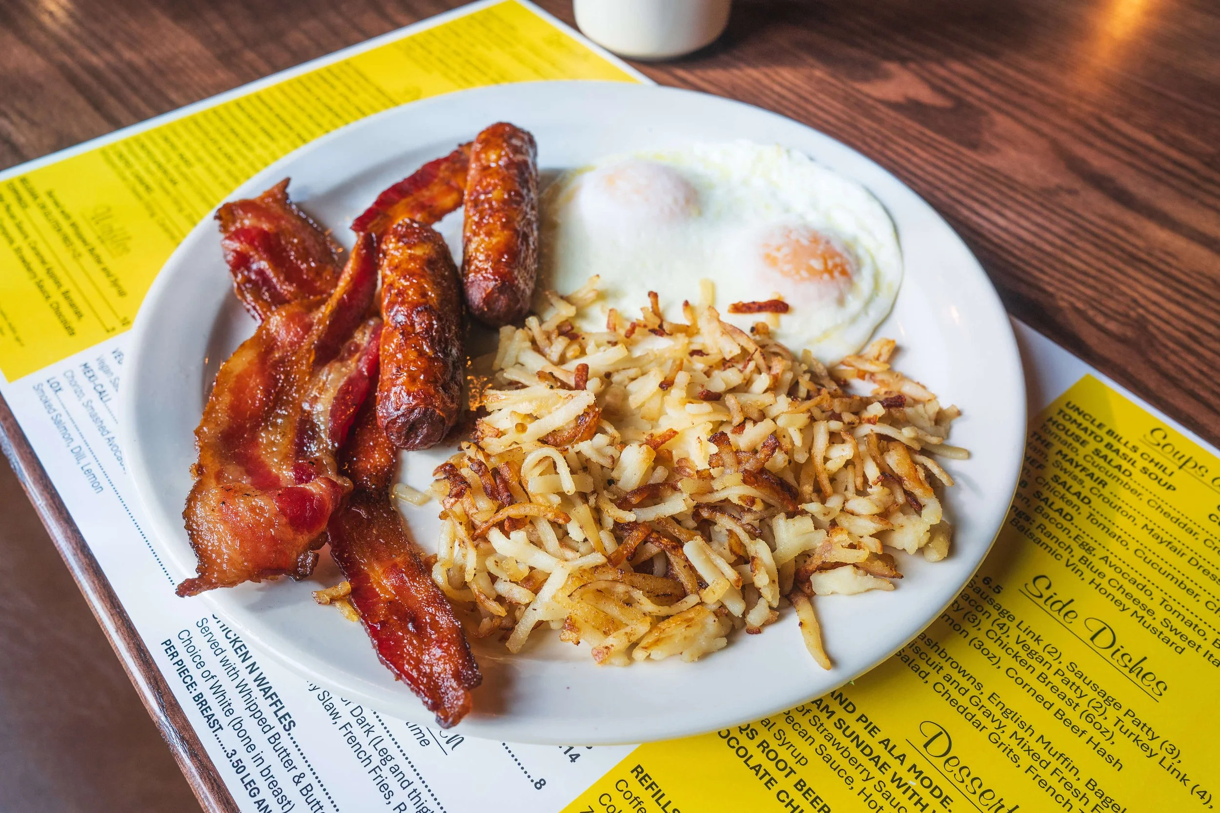 Classic diner breakfast with eggs, bacon, sausage, and hashbrowns at Uncle Bill’s Pancake House