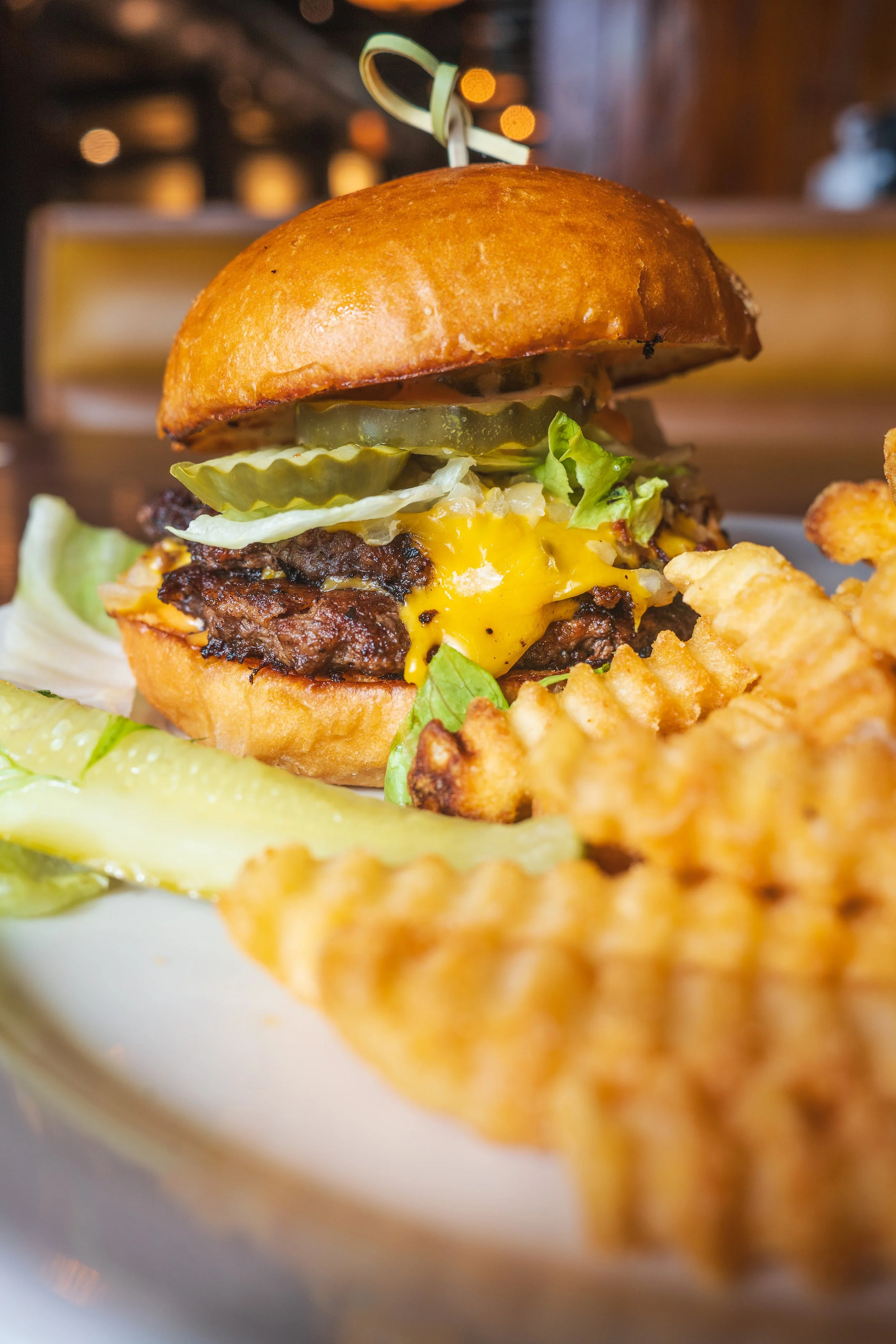 Cheeseburger with lettuce, pickles, fries, and a pickle spear at Uncle Bill’s Pancake House