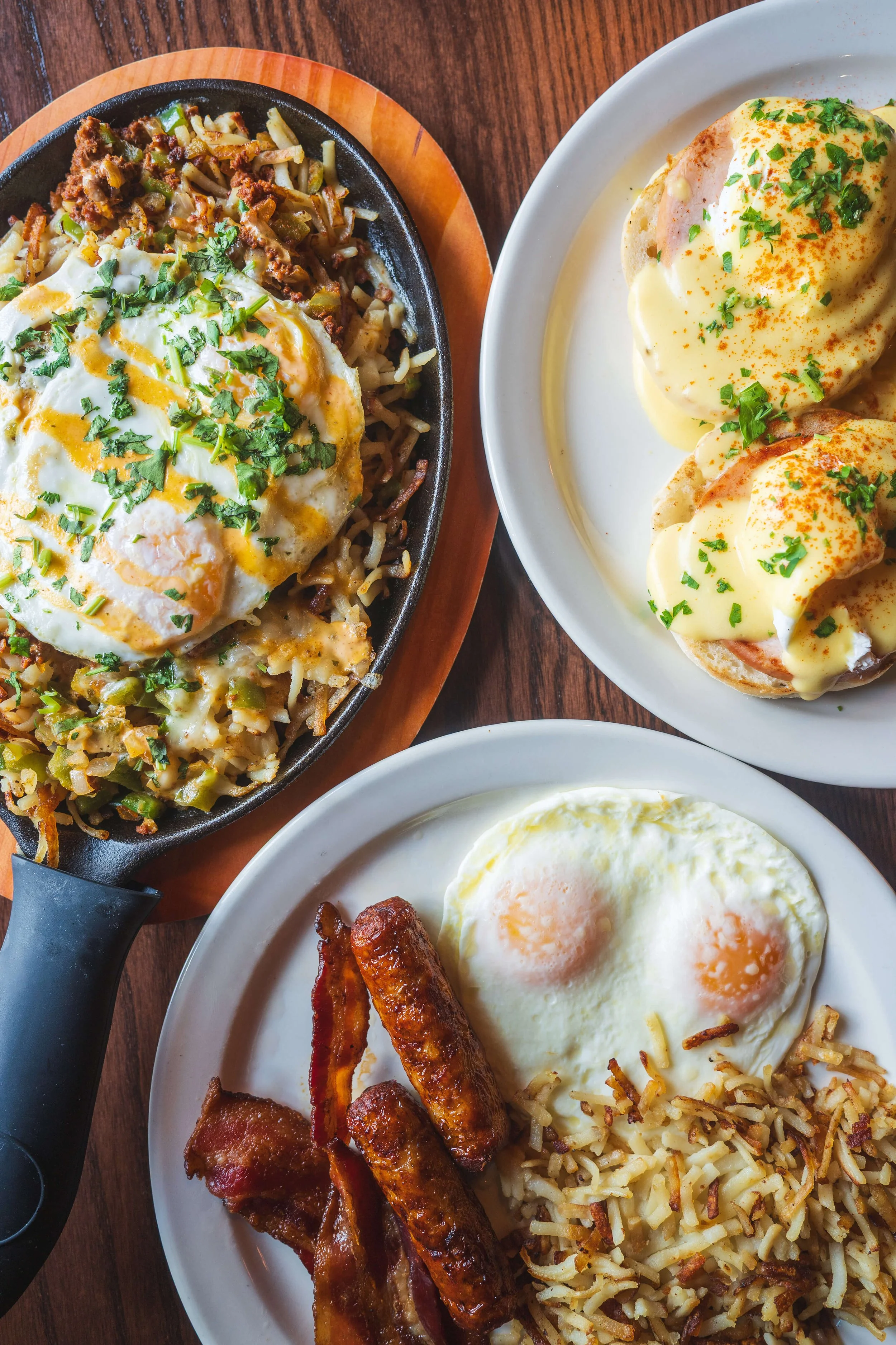 Breakfast table spread featuring pancakes, eggs Benedict, and skillet dishes at Uncle Bill’s Pancake House