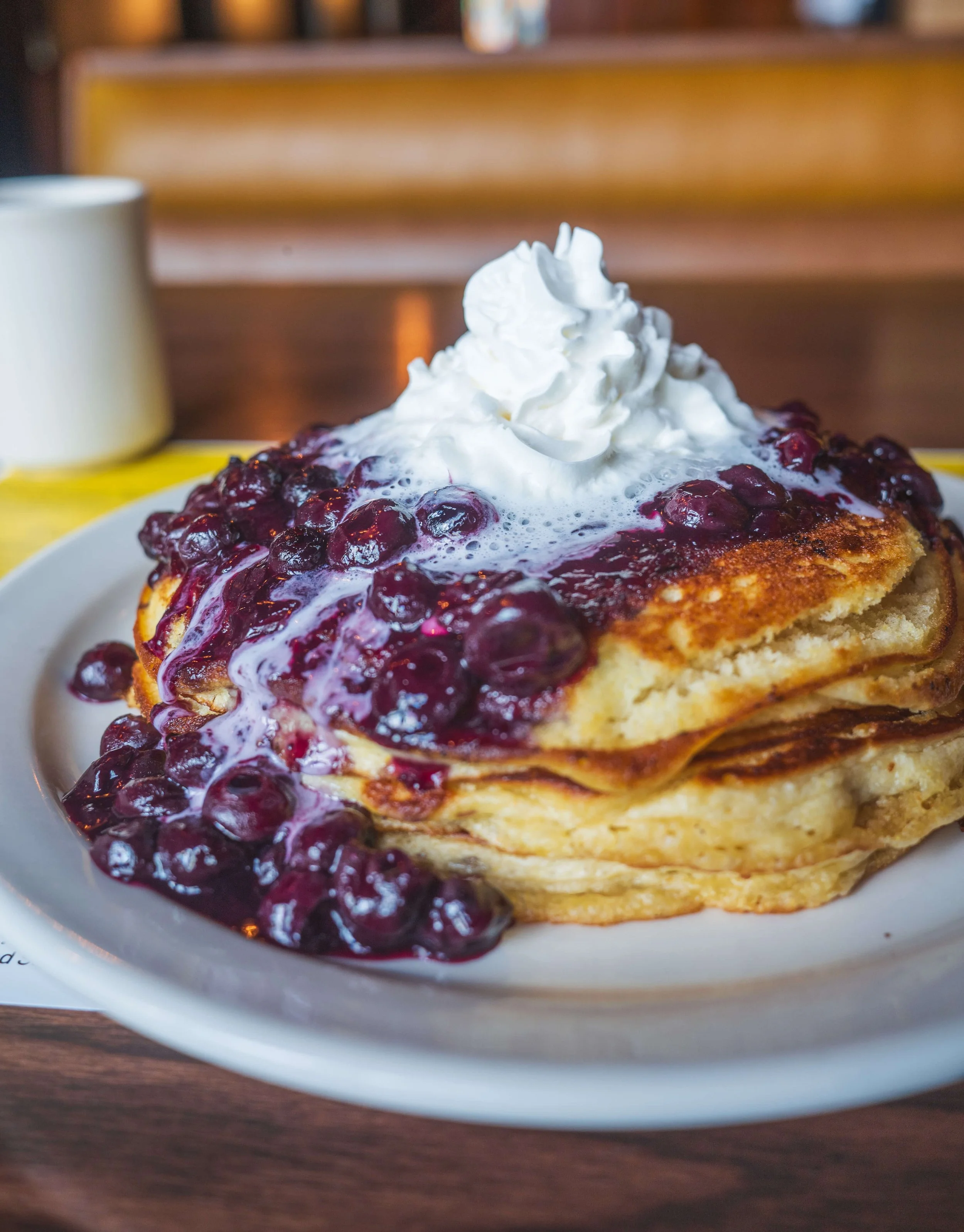 Fresh blueberry pancakes topped with whipped cream at Uncle Bill’s Pancake House in South St. Louis