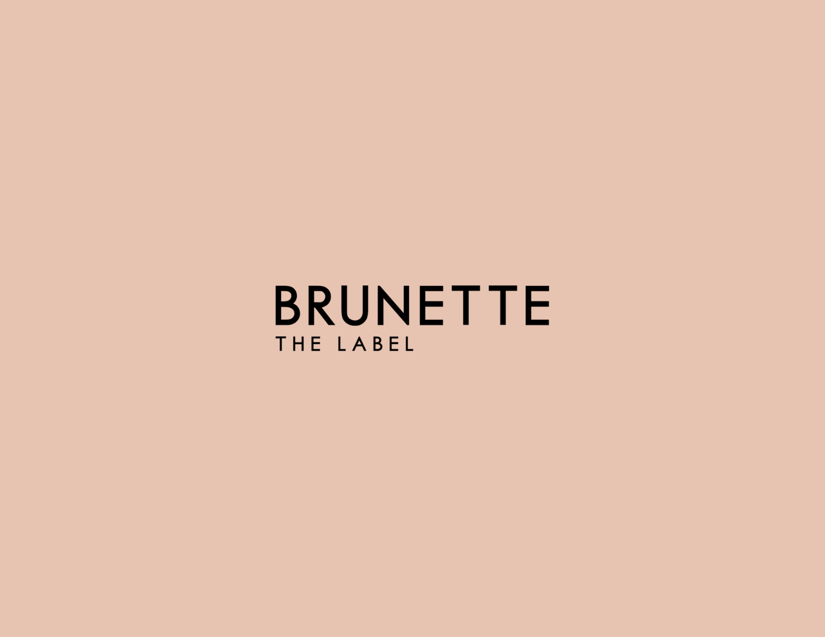 Pink background with black text that reads "BRUNETTE THE LABEL."