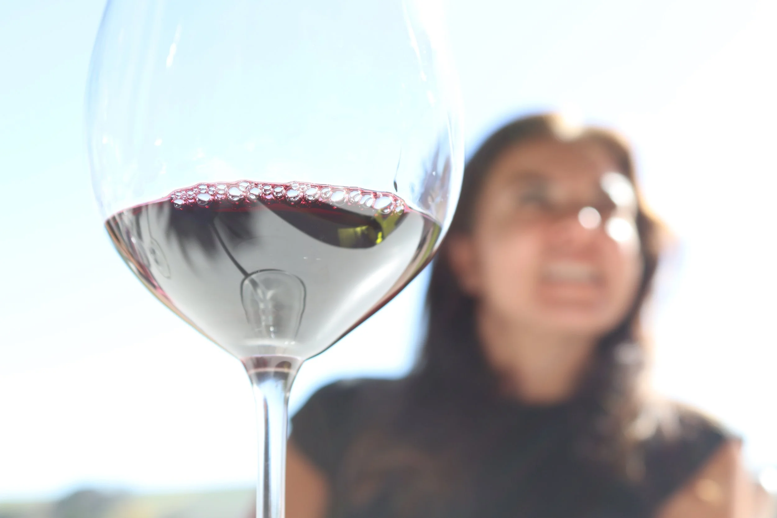 A woman enjoying her wine at the Seven Sisters vineyard