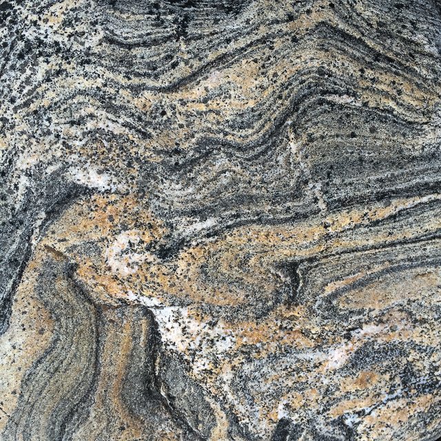 Banded metamorphic rock layers, serving as a metaphor for the deep, psychodynamic therapy practiced by Dr. Jeremy Steglitz, a psychologist in DC and NY.