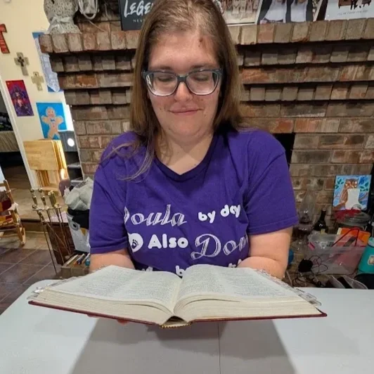 Doula Melanie Powell prayerfully reading the bible
