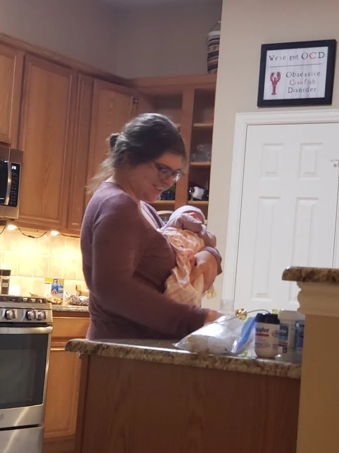 "Doula Melanie Powell giving a newborn a bottle as a part of her nighttime postpartum doula package."