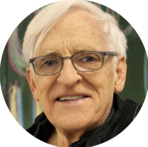 Portrait of an elderly man with white hair and glasses.