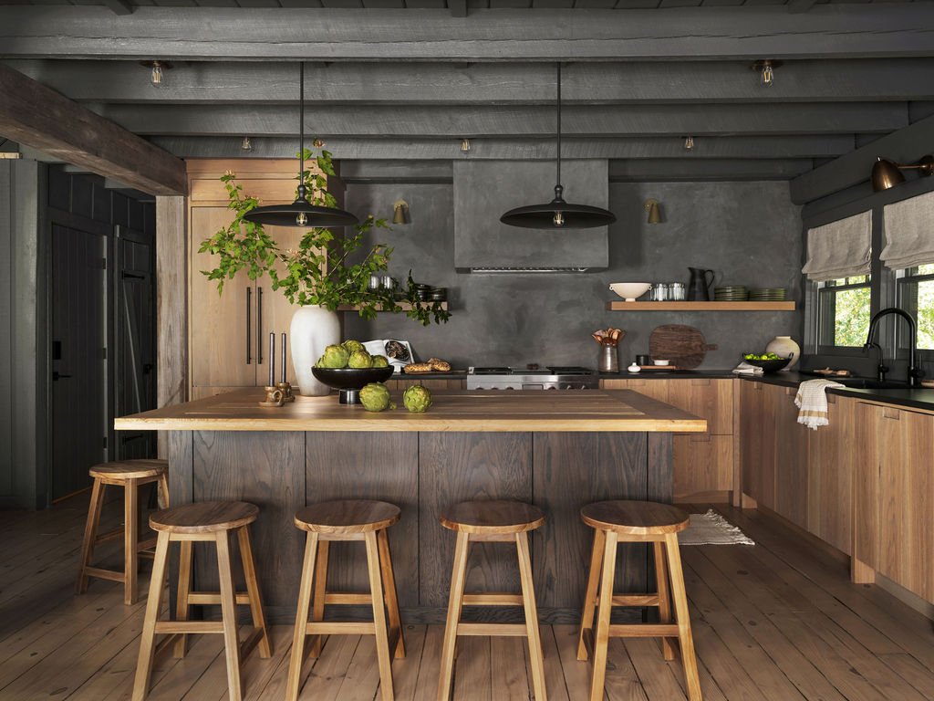 Modern kitchen with wooden cabinets, a large wooden island with four stools, a gray concrete wall, and large windows with blinds.