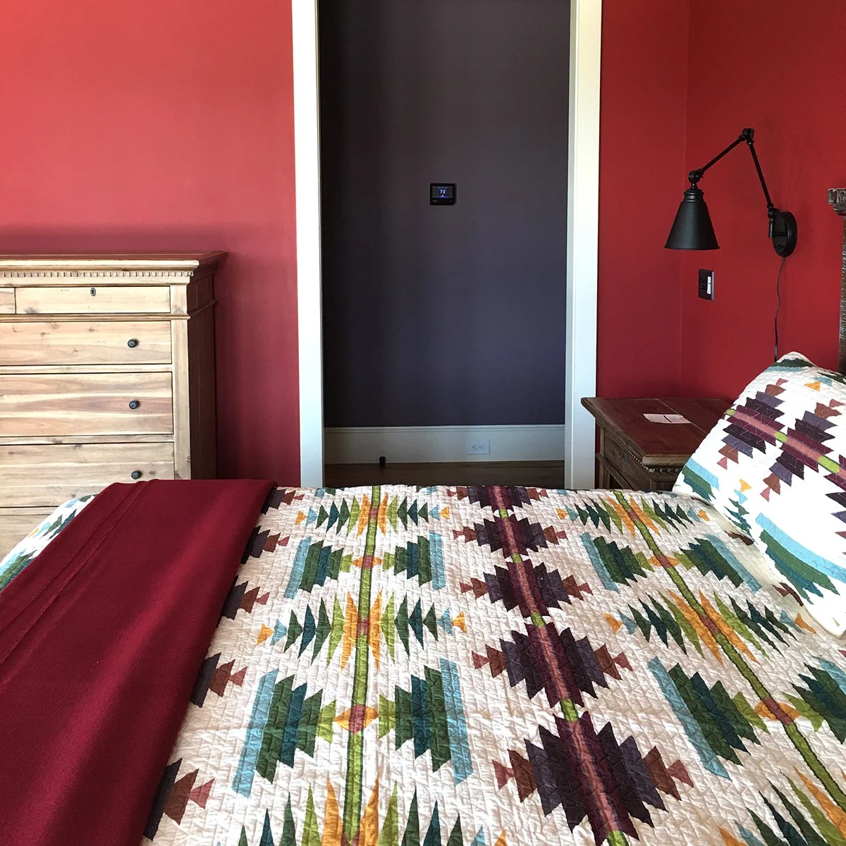 farm house 2nd bedroom, red walls, western quilt
