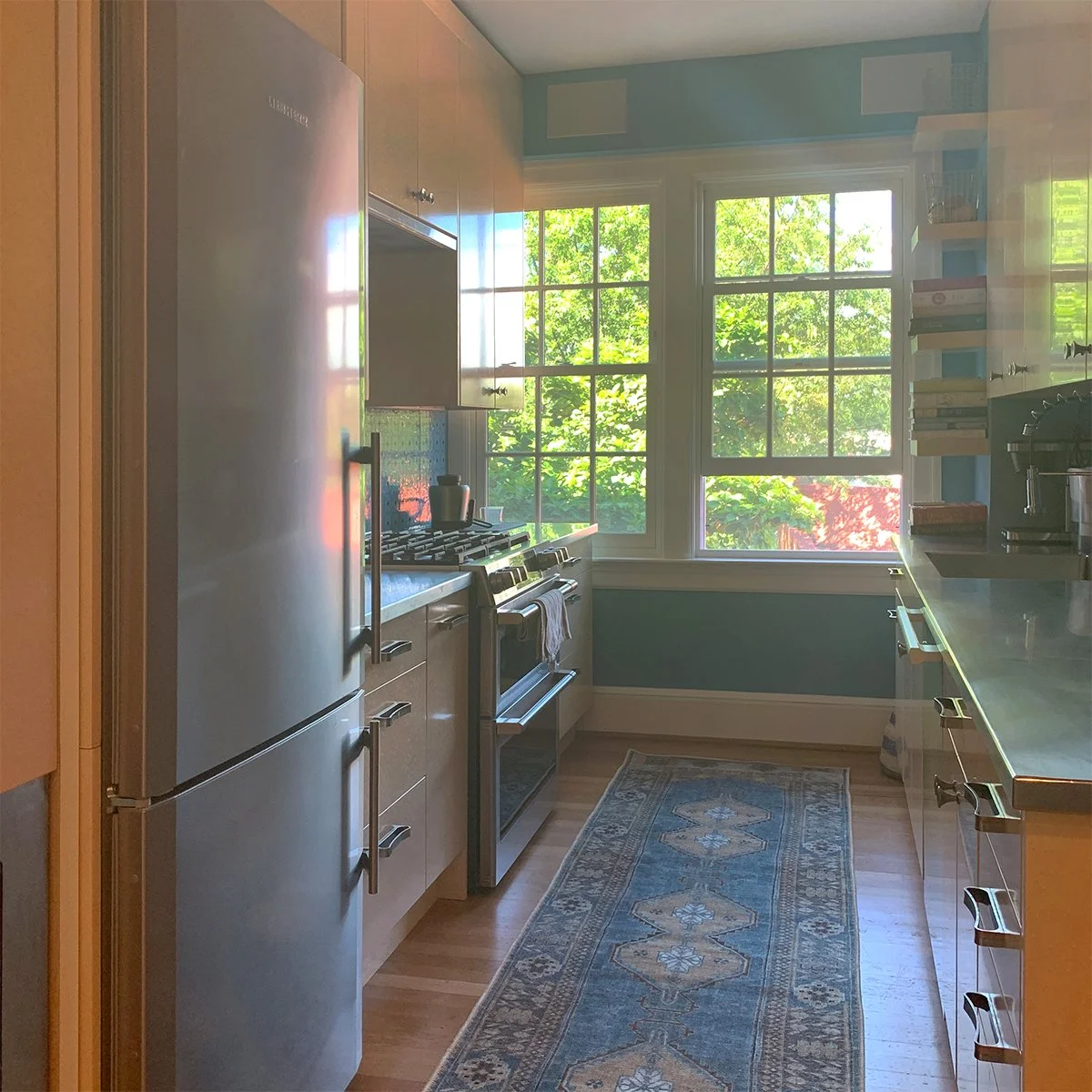 galley kitchen with blue wall