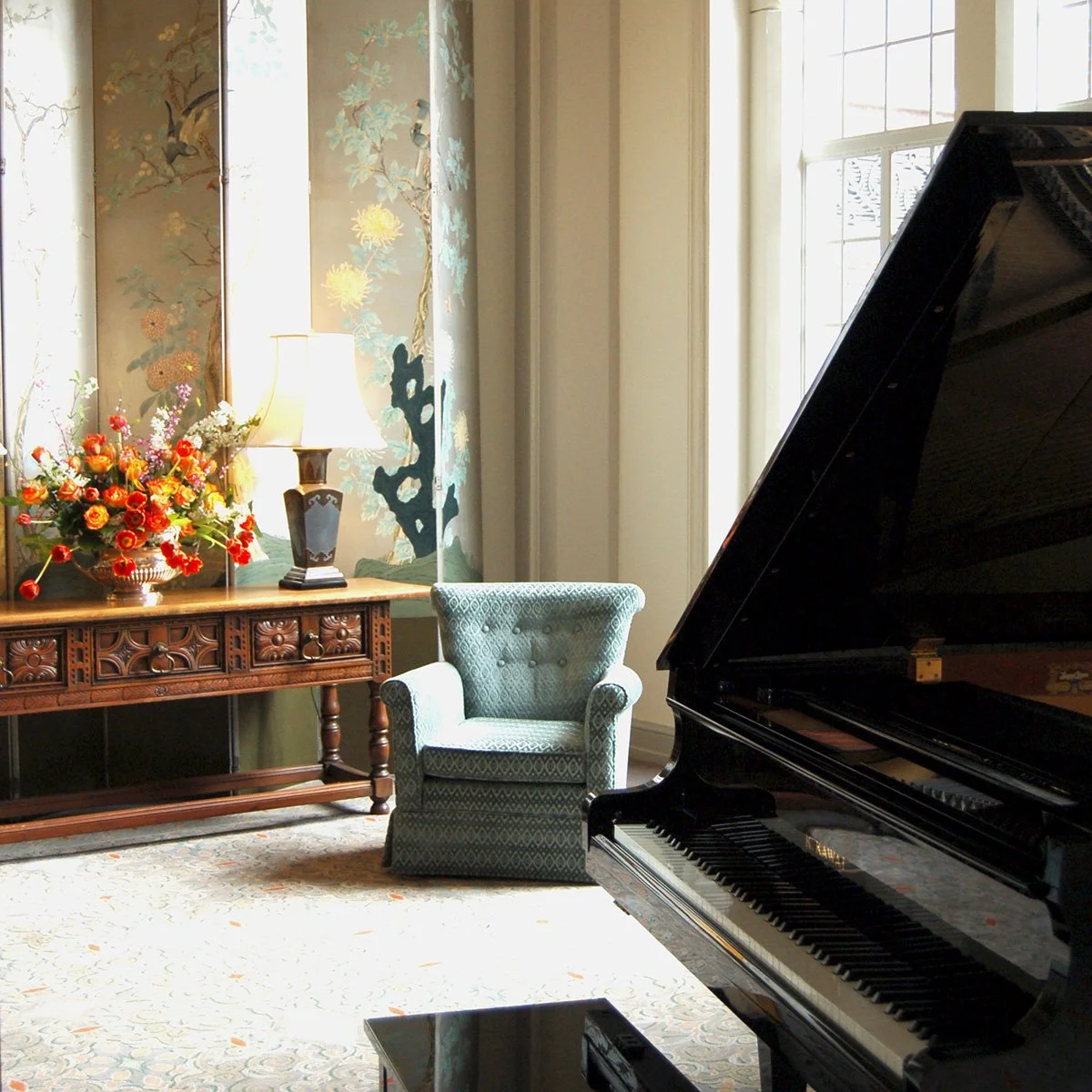 formal living room with antique furniture and grand piano