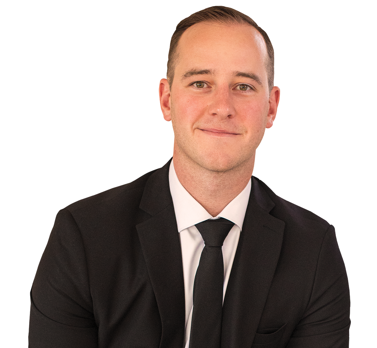 Portrait of Cameron Prukner in a black suit, white shirt, and black tie, smiling against a plain background.