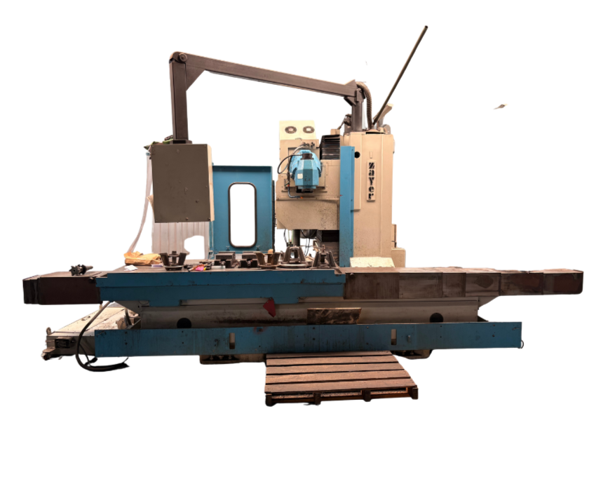 Industrial CNC milling machine on a worktable with various components, in a workshop setting.