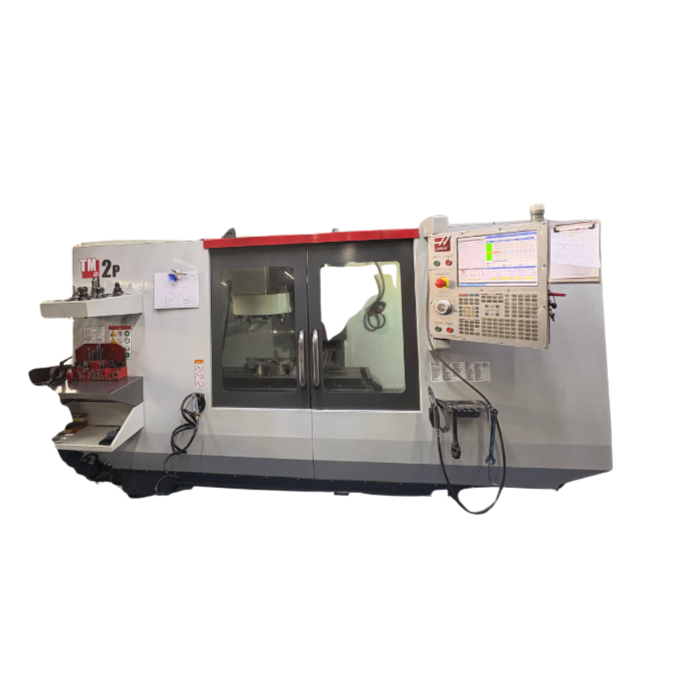 Industrial CNC machine with control panel, safety doors, and workspace, used for manufacturing or machining tasks.