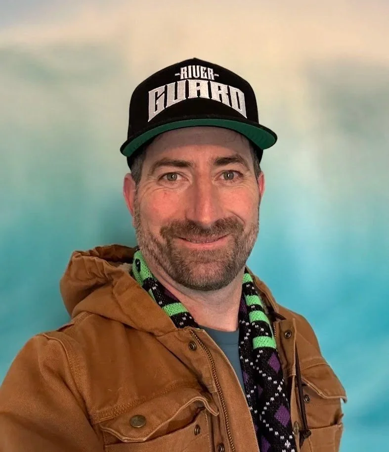 Headshot of Brian Stuhr wearing The River Guard hat and scarf