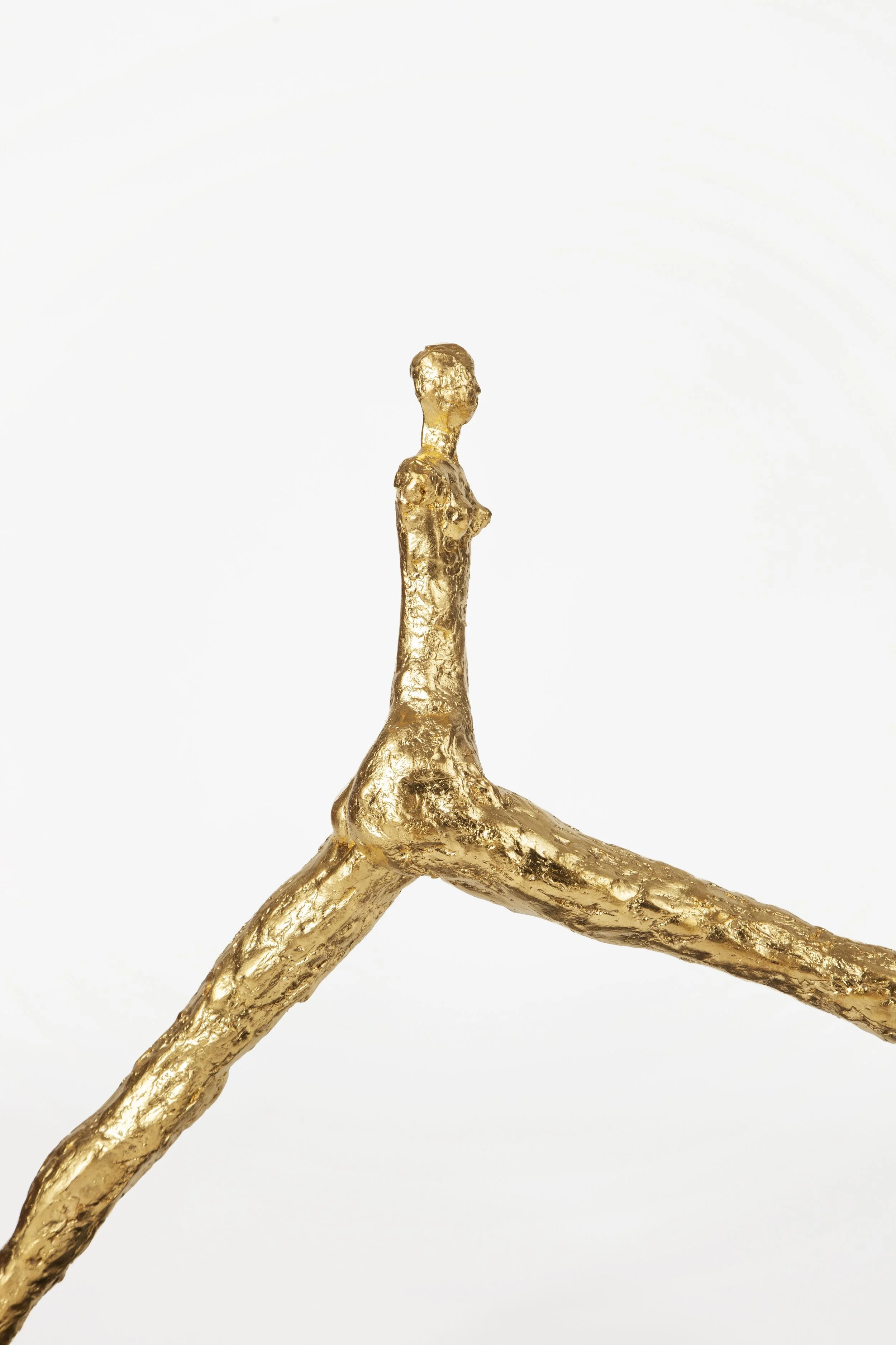 Gold sculpture with white background