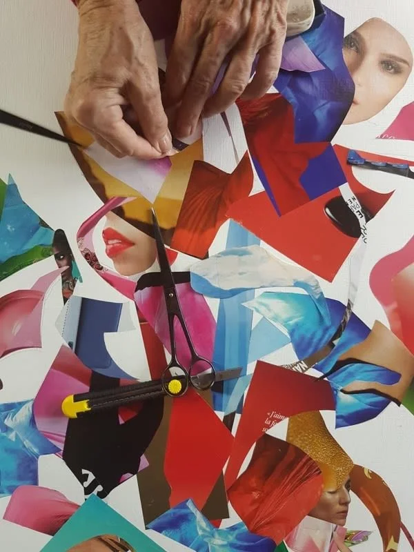 A collage of cut-out magazine images of women, with a pair of scissors and a utility knife on top.