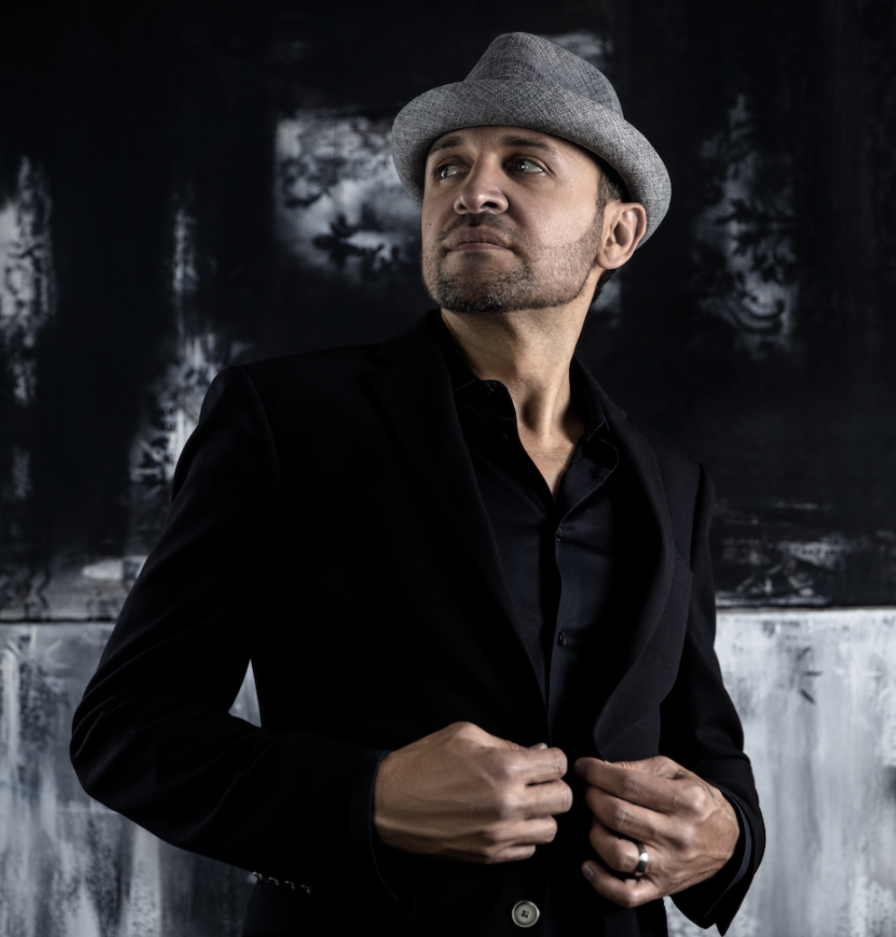 Man in hat and black suit