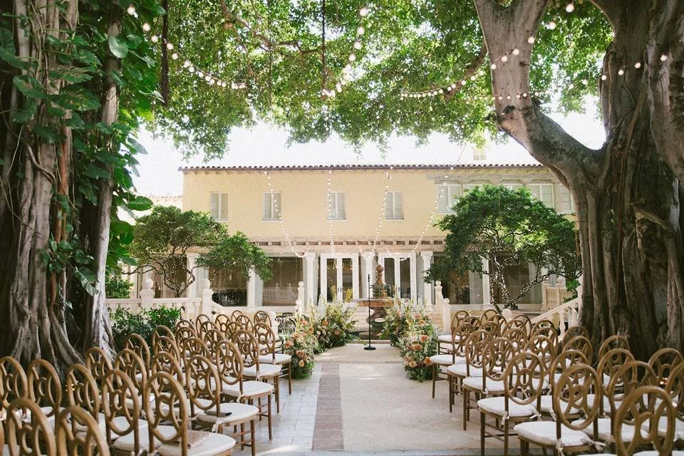 The Addison Boca Raton luxury wedding venue with historic 1920s Spanish Revival architecture and banyan trees.