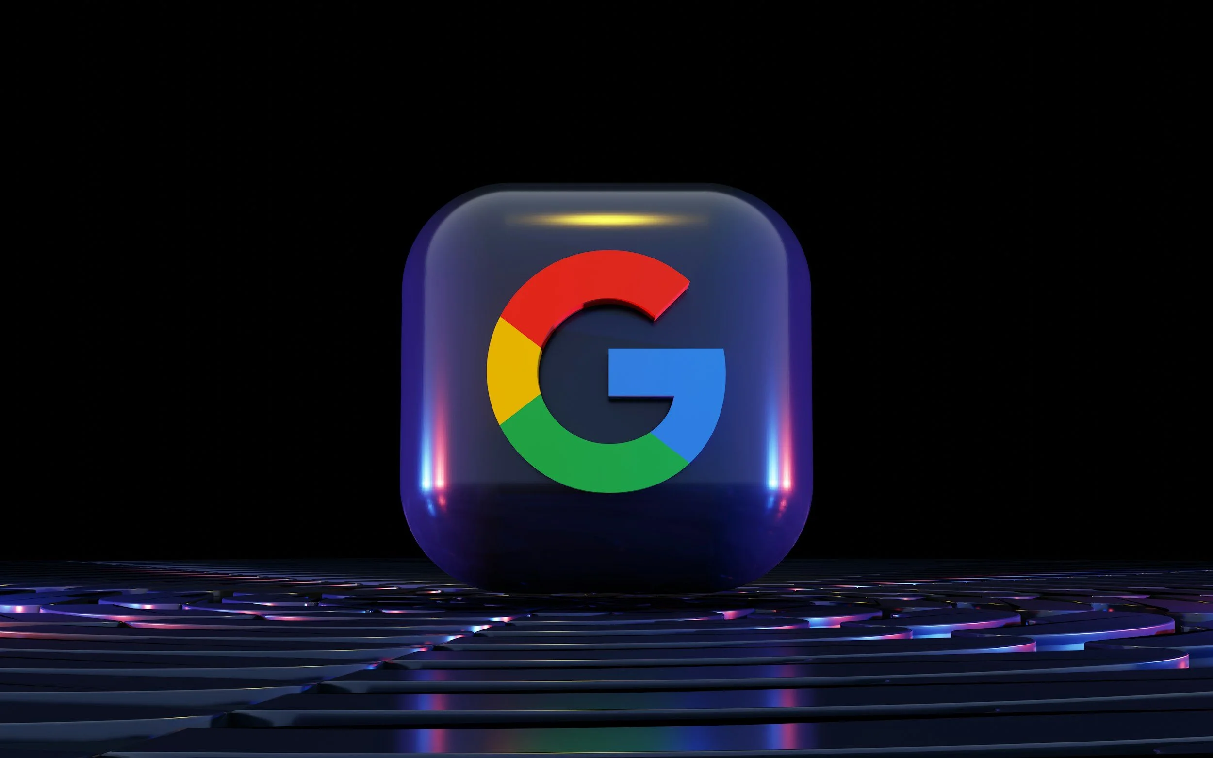 A digital rendering of a Google icon inside a shiny, black, rounded square with colorful lights reflecting off its surface, set against a dark background.