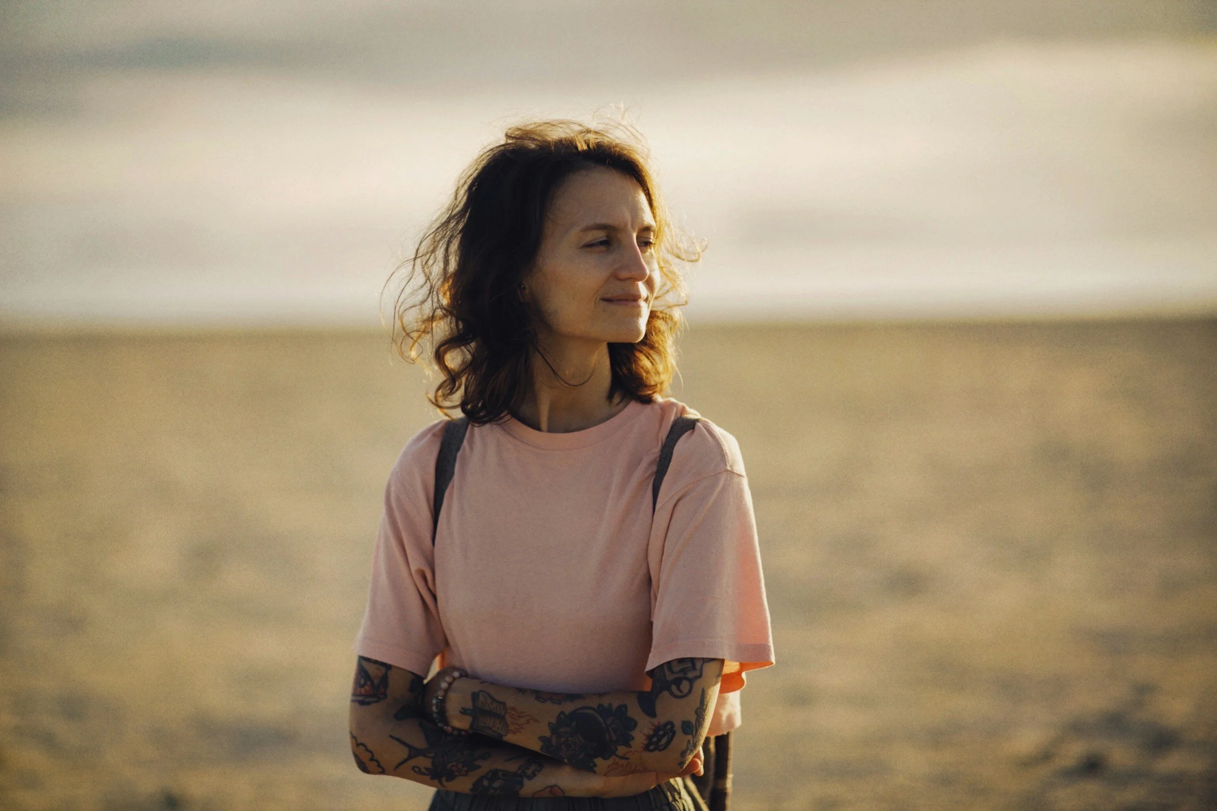 Woman walking on the beach processing after trauma therapy in Camas, Washington