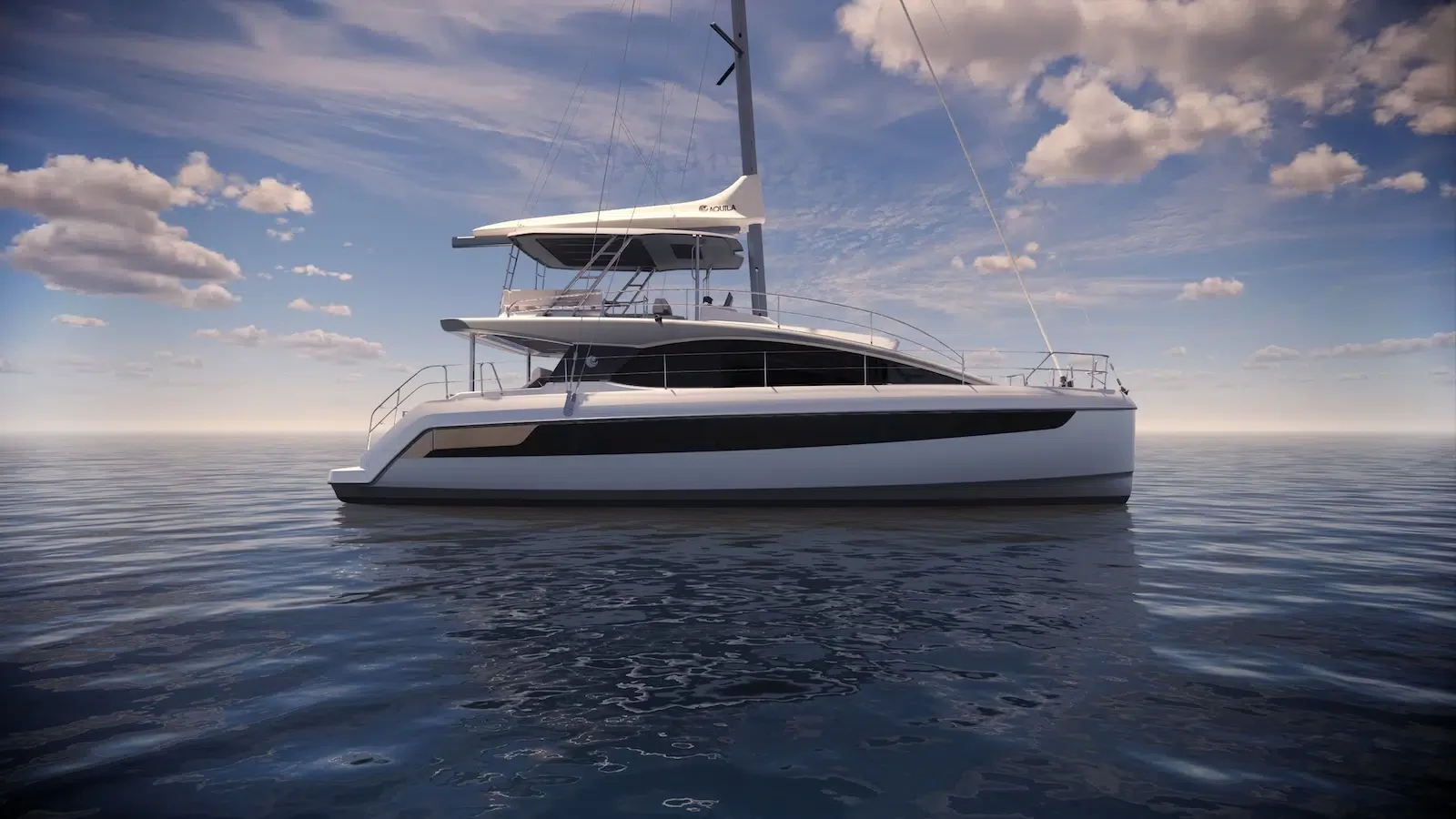 A modern white and black sailing yacht floating on calm ocean water under a partly cloudy sky.