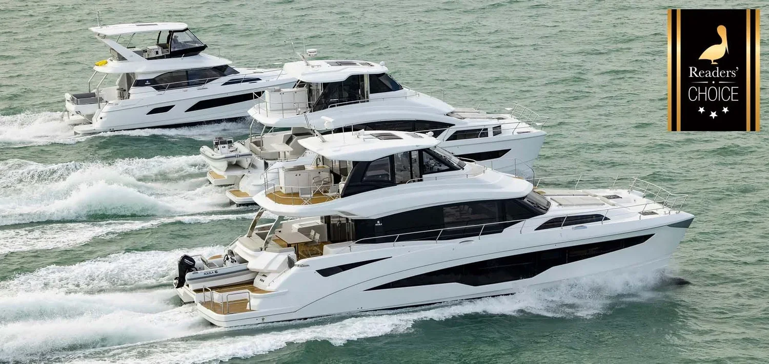 Three white luxury yachts sailing in the water, viewed from above. A 'Readers' Choice' award badge is in the top right corner.