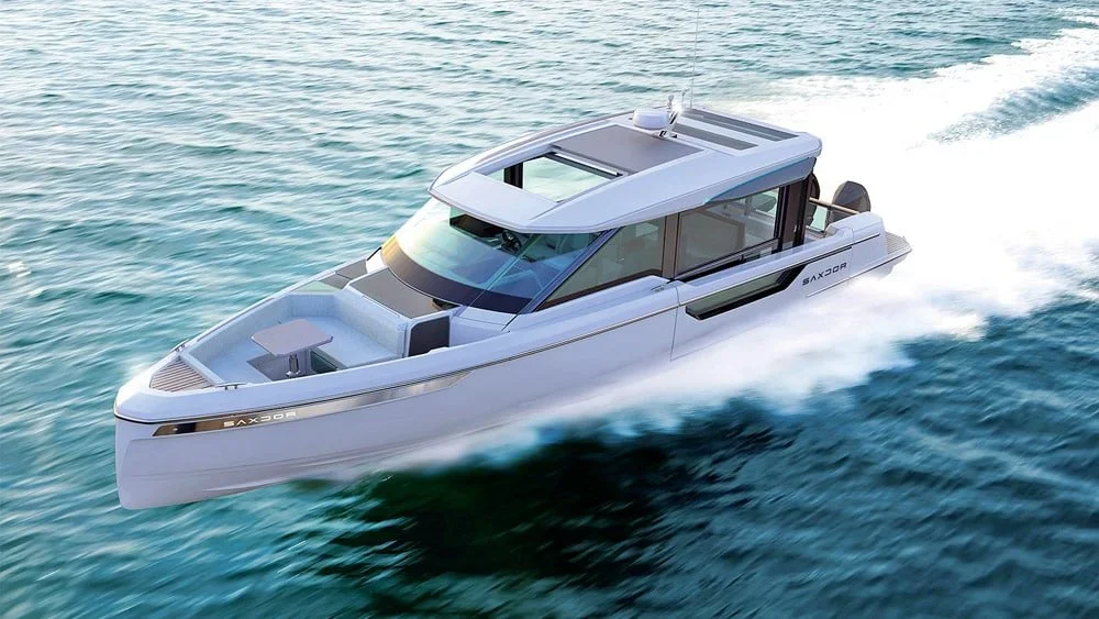 A sleek, modern yacht cruising on the water, creating a trail of white foam behind it.