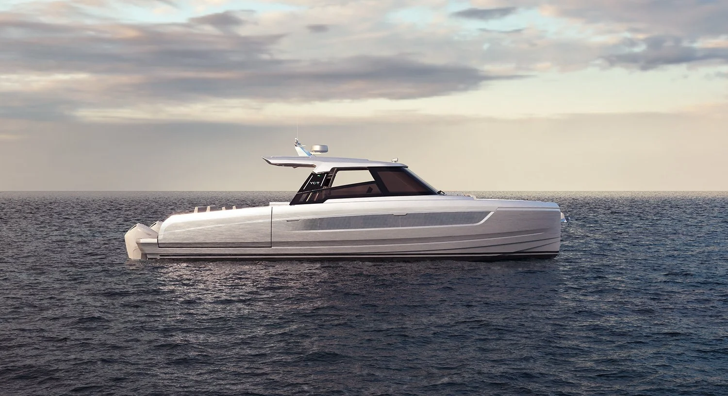 A modern yacht floating on the ocean with a cloudy sky in the background.