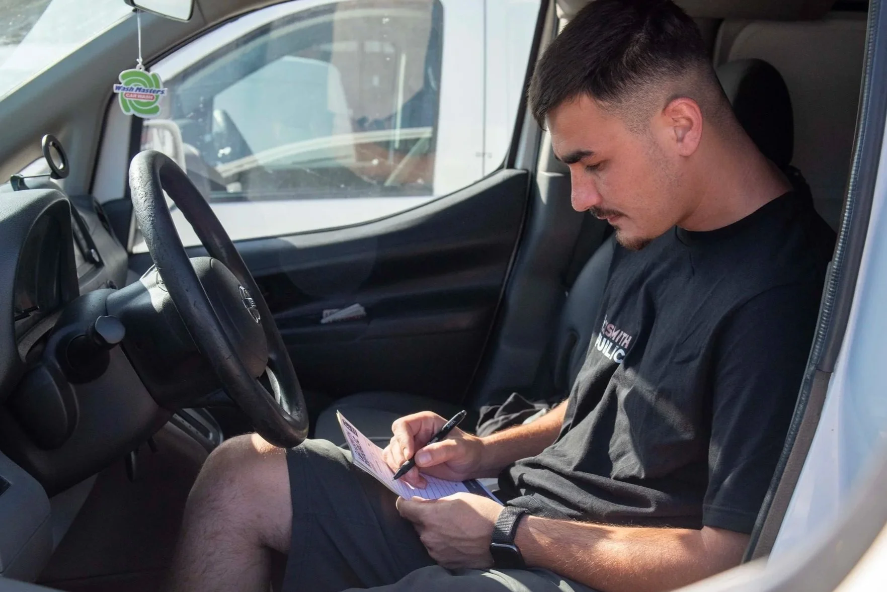 Republic Locksmith technician verifying a customer's identification before creating a replacement car key