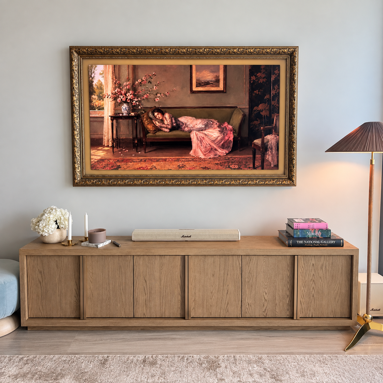 Art-style TV professionally mounted above a custom wood media console, featuring an ornate decorative frame, concealed wiring, and a flush installation designed to blend seamlessly with the room’s décor.