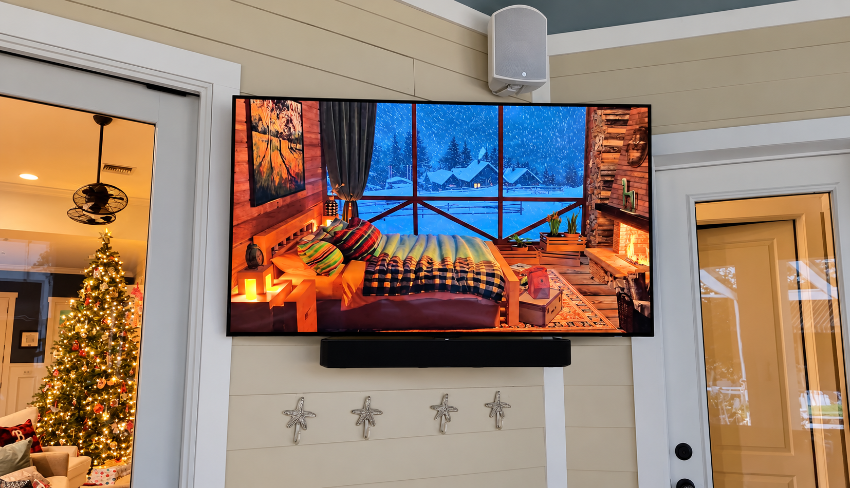 Professionally mounted outdoor TV with soundbar and wall-mounted speaker on a covered patio in South Tampa, FL, by Precision Smart Home.