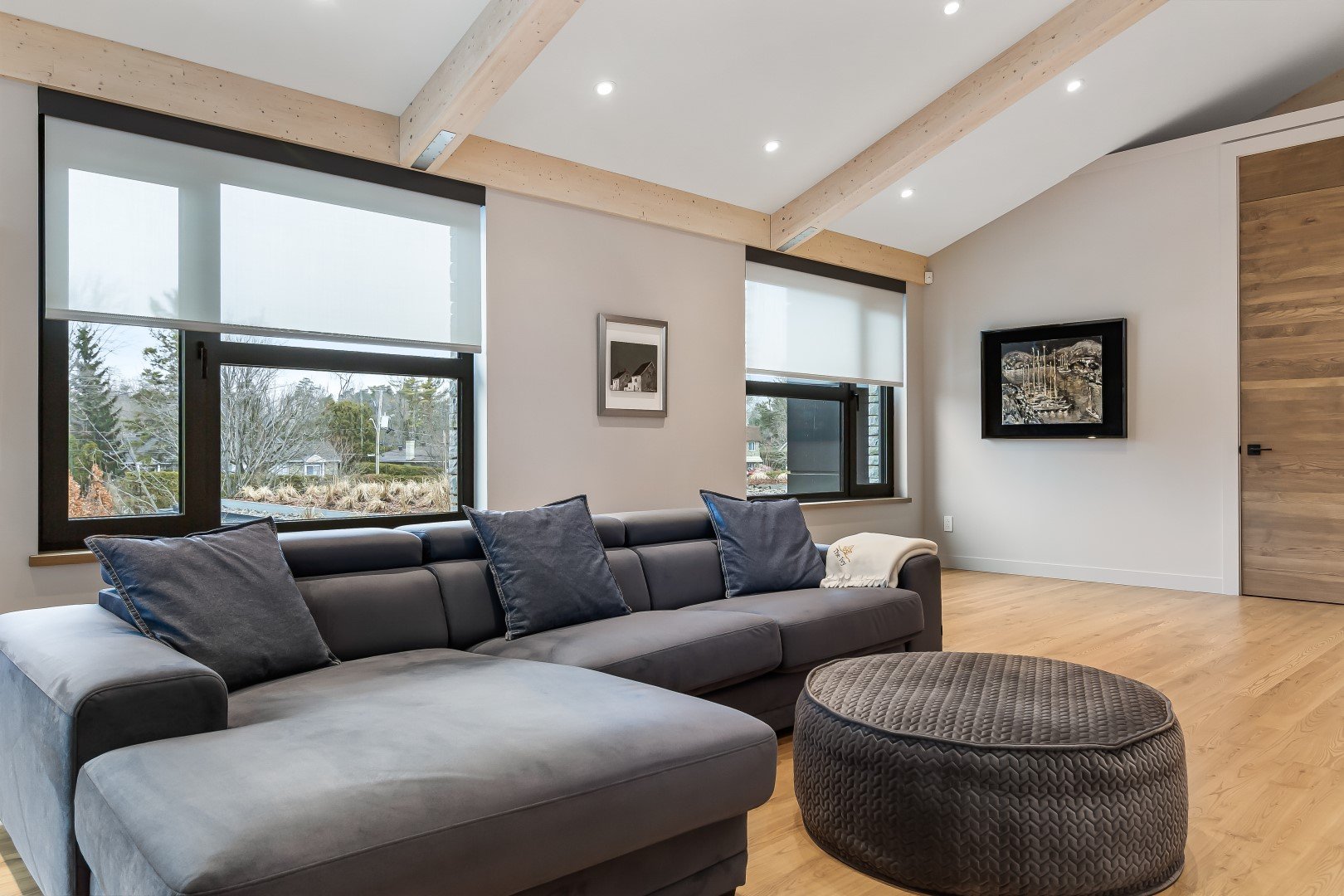 Motorized window shades providing light control in a modern living room