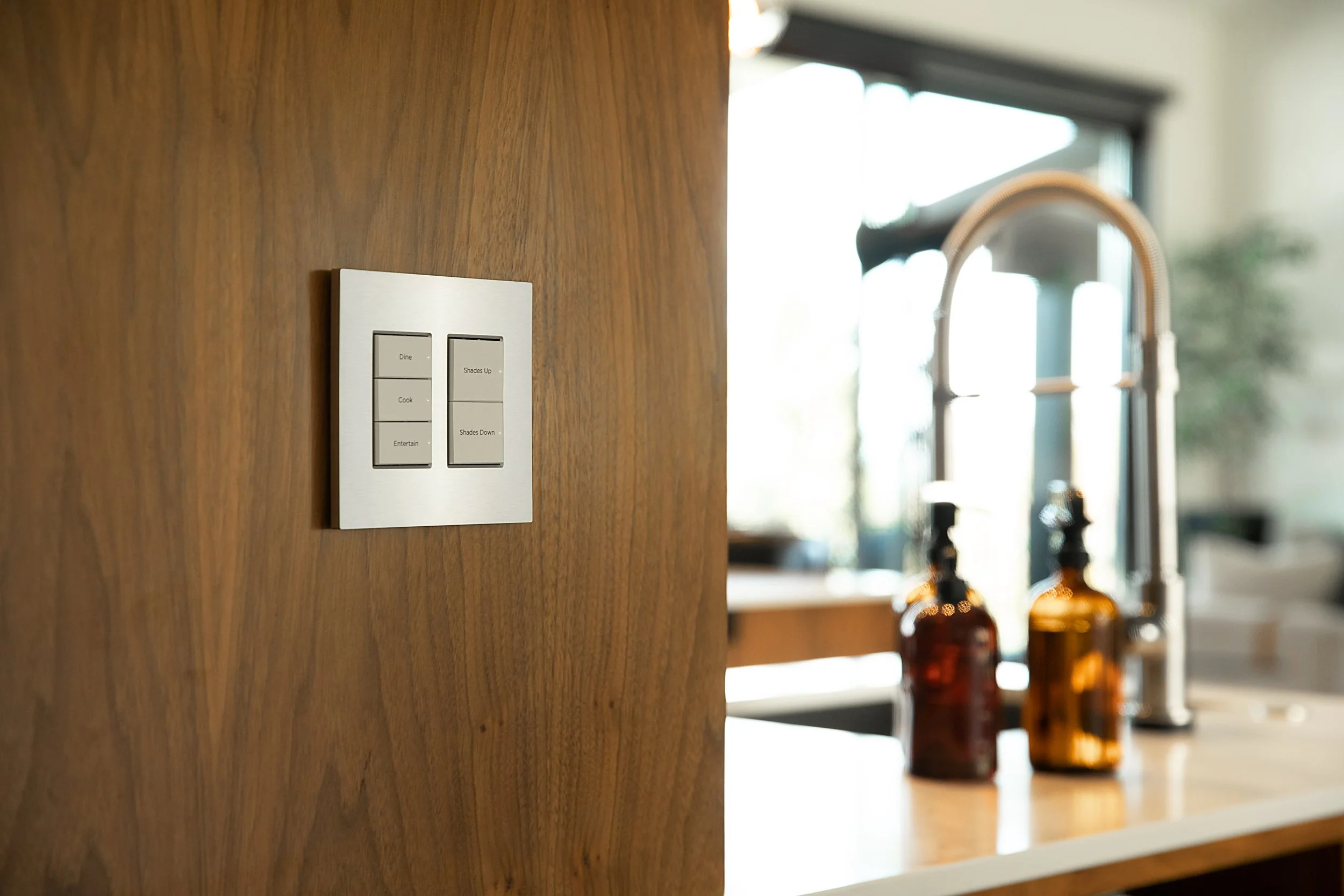 Smart lighting control keypad installed in a modern kitchen