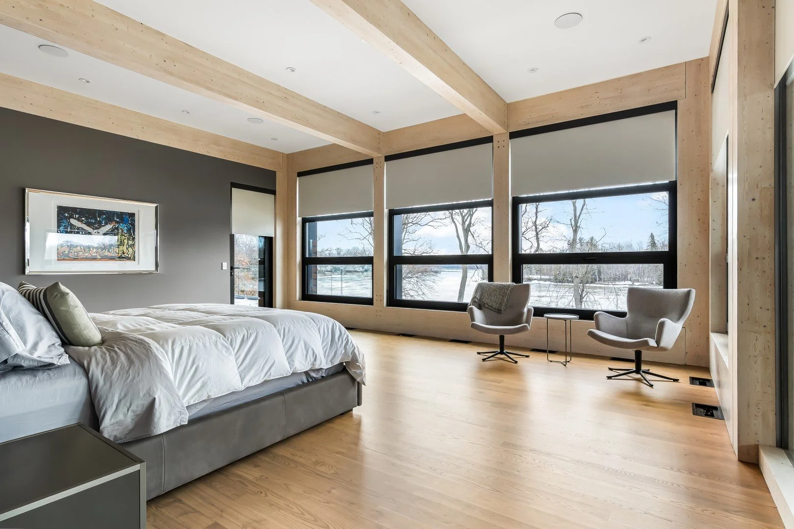 Motorized shades installed across multiple windows in a modern bedroom