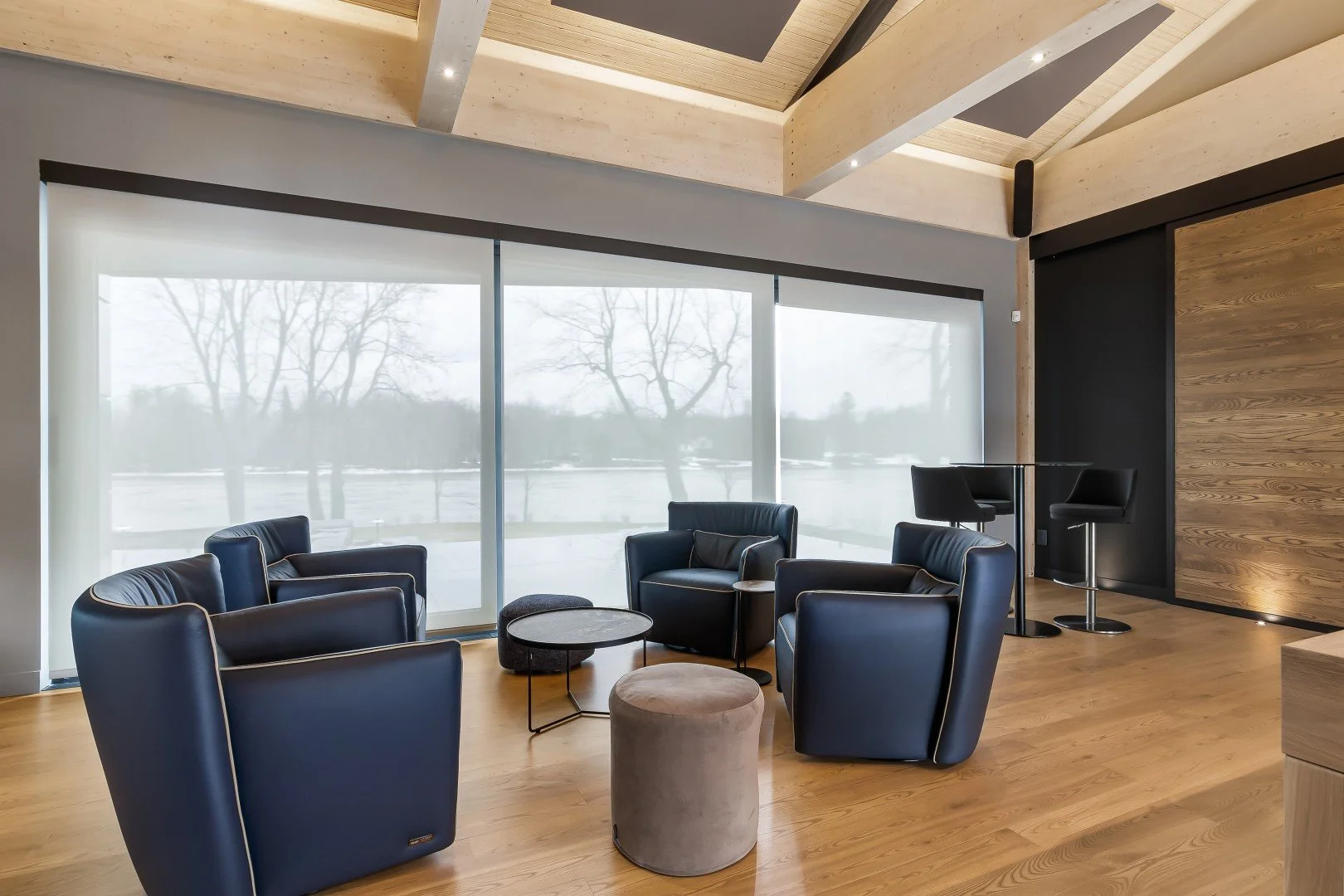 Motorized roller shades in a modern living space with large windows