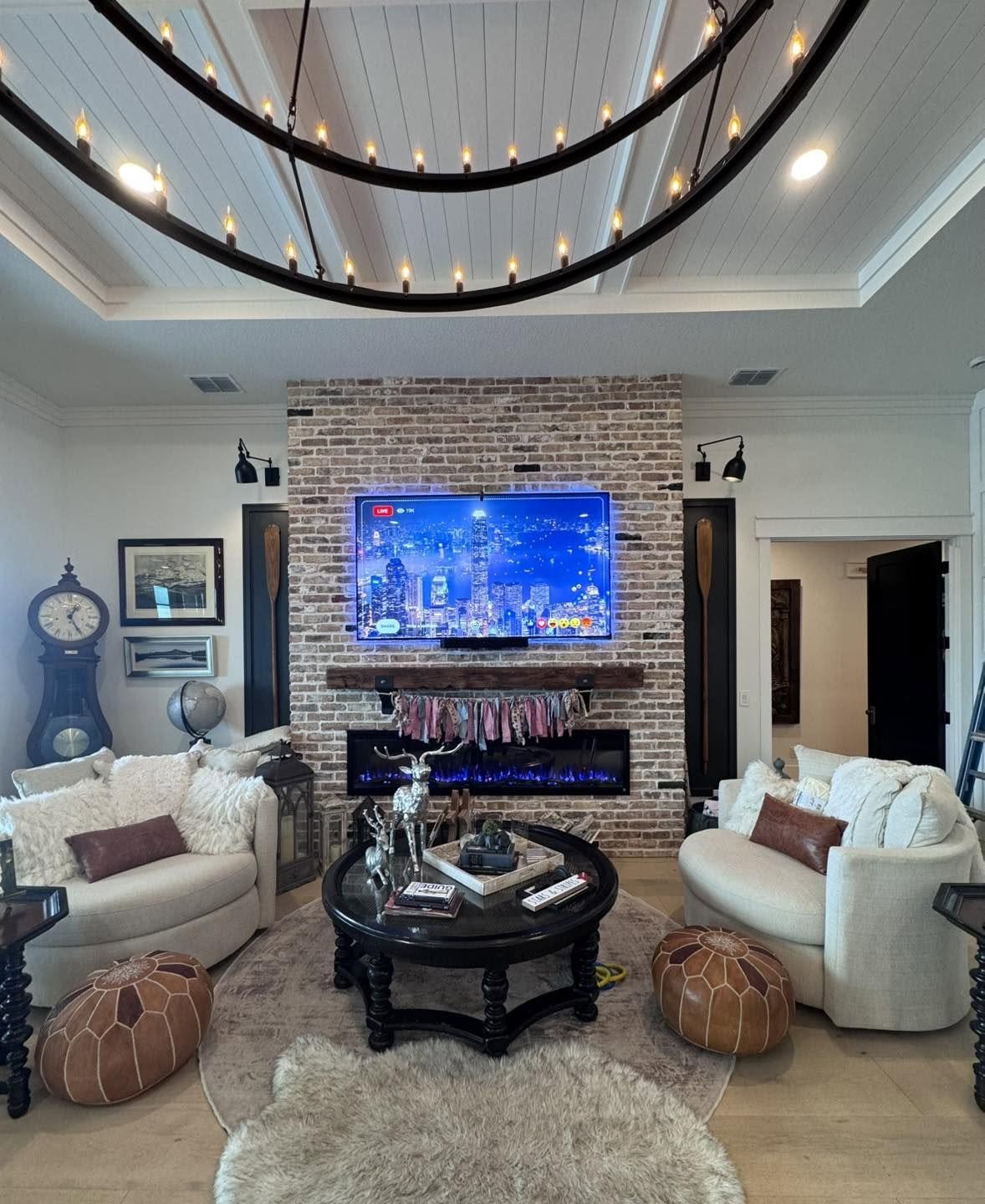 Wall-mounted TV above a brick fireplace in a Ruskin, Florida whole-home audio and multi-TV installation.