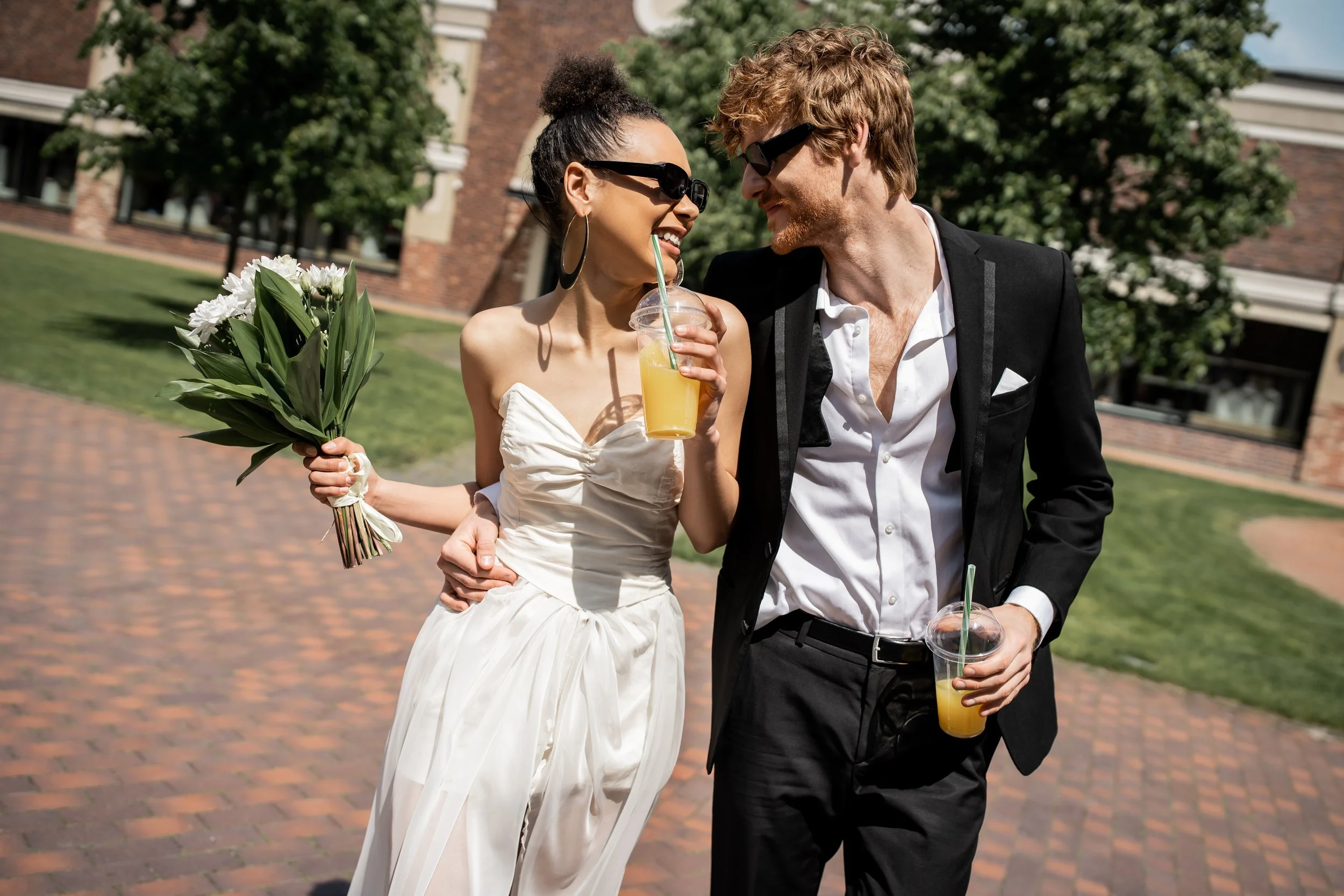 joyful-multiethnic-newlyweds-in-sunglasses-walking-2024-11-10-22-11-05-utc.jpg