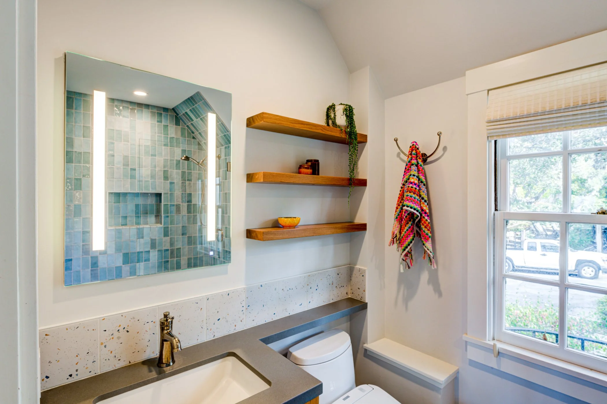 Bathroom with blue tile scheme and fixtures.