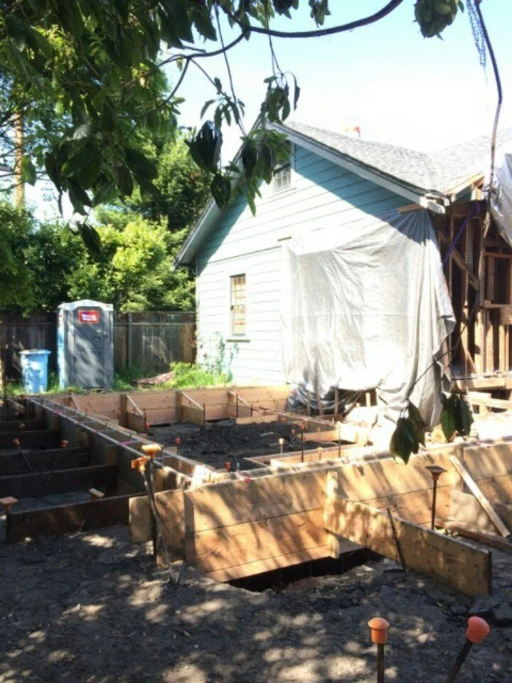 Foundation forms prepared at the rear of the home, outlining the footprint for the new kitchen and family room addition before concrete was poured.