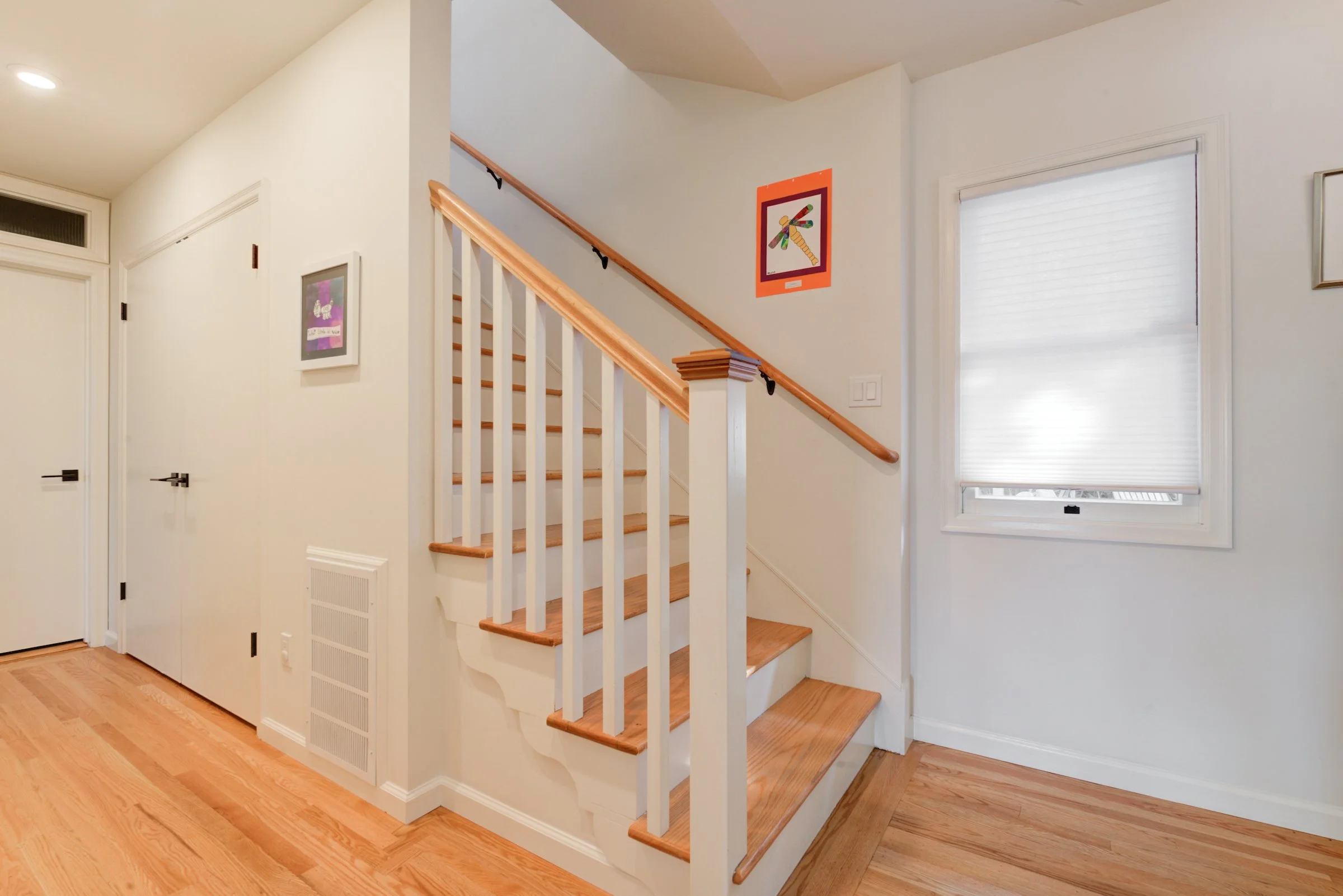 Stairway to match the new aesthetic, with painted balusters and risers and natural wood treads and railing